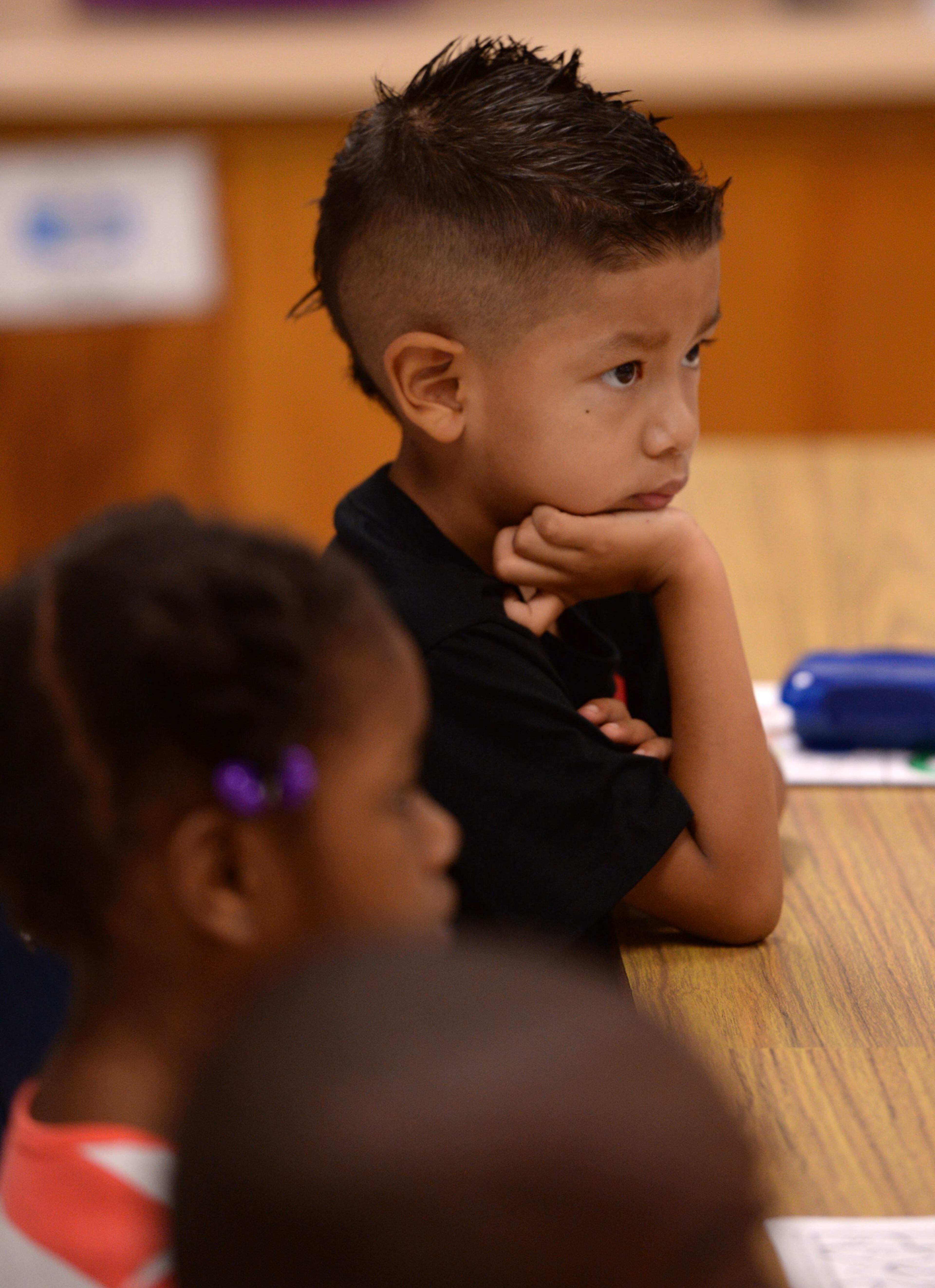 Brian Ortega - Noriega sits and listens for instructions from his teacher on the first day of school at Midvale Elementary on Monday, August 12, 2013. JOHNNY CRAWFORD / JCRAWFORD@AJC.COM