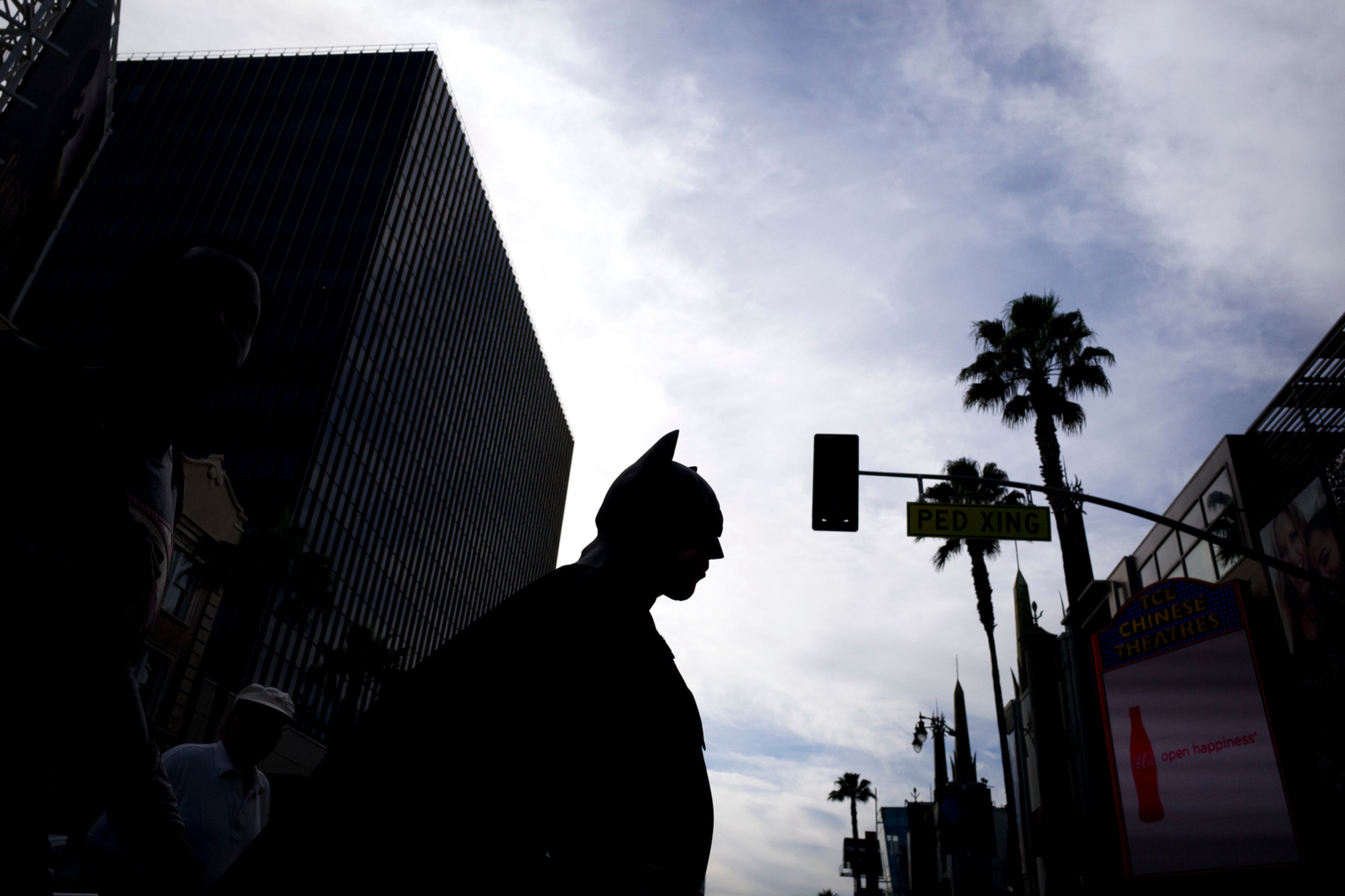 Wearing a Batman costume, impersonator Justin Harrison walks across Hollywood Boulevard Monday, Feb. 13, 2017, in the Hollywood section of Los Angeles. (AP Photo/Jae C. Hong)