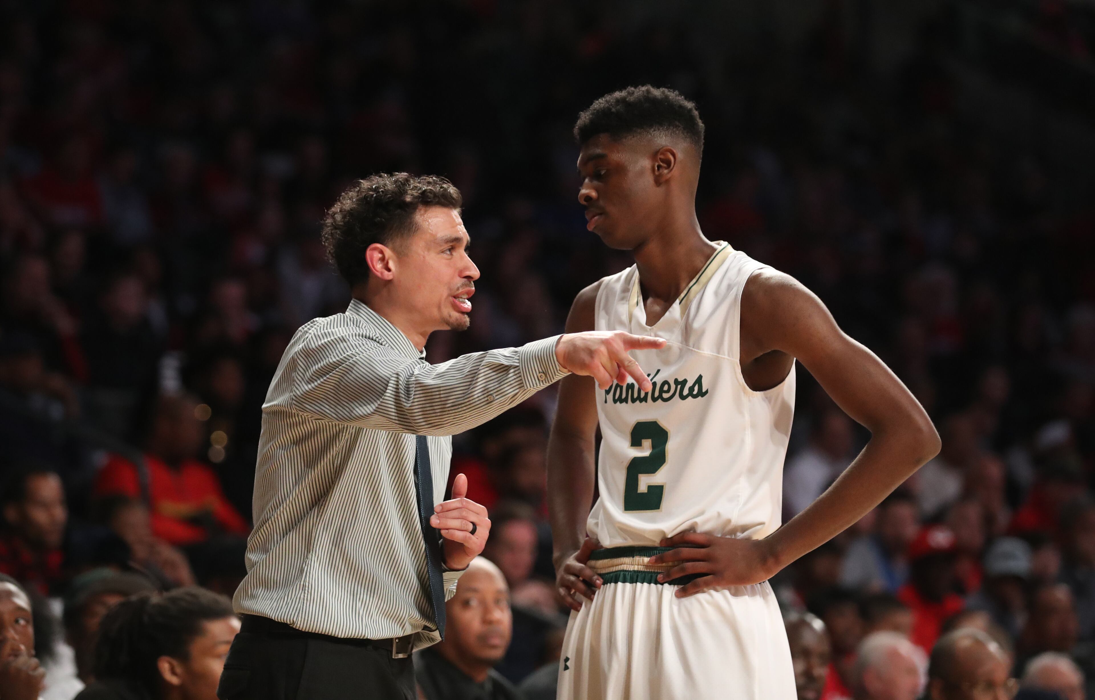 March 9, 2018 - Atlanta, Ga: Hughes coach Rory Welsh talks with guard Patrick Carter Jr. (2) during the first half against Gainesville during the GHSA Class AAAAAA Boys State Championship at McCamish Pavilion Friday, March 9, 2018, in Atlanta. Hughes won 85-78. PHOTO / JASON GETZ