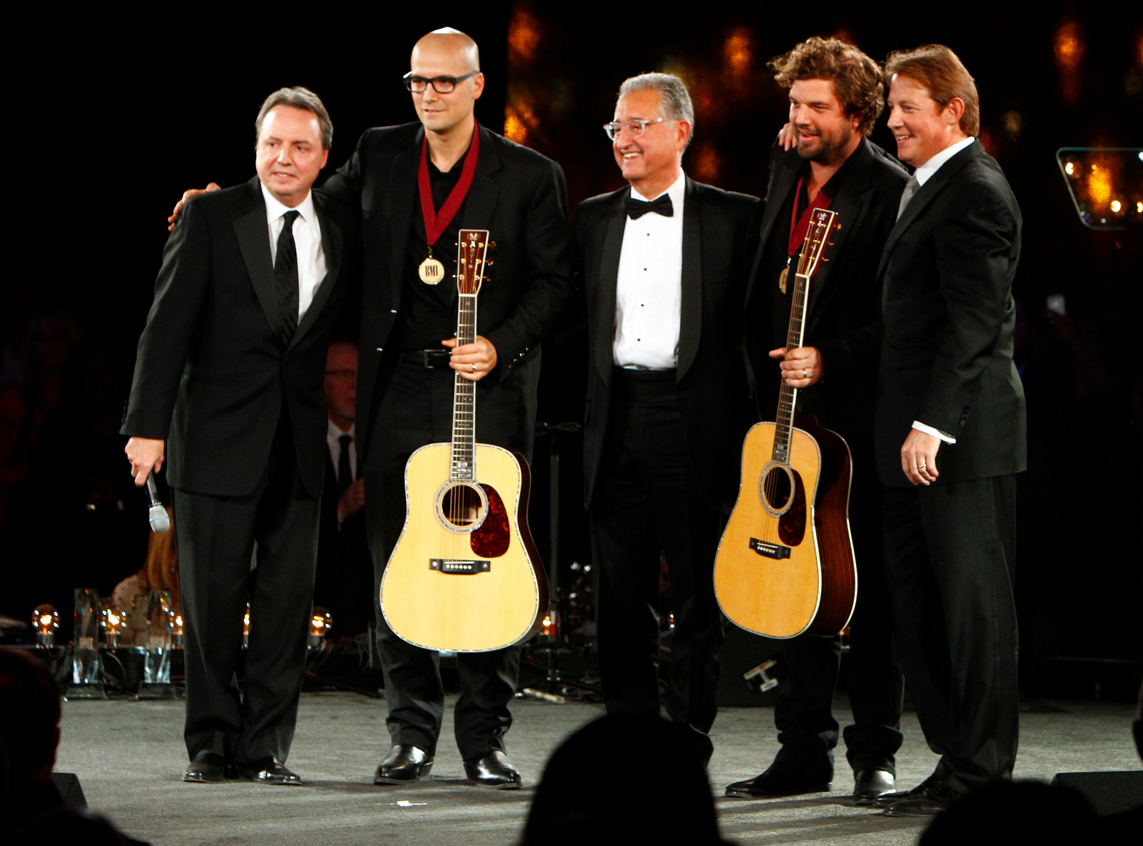 Luke Laird, second from the left, and Dallas Davidson, fourth from the left, stand with Jody Williams, left, Del Bryant, center, and Clay Bradley after winning Songwriter's of the Year at the 60th Annual BMI Country Awards on Tuesday, Oct. 30, 2012, in Nashville, Tenn.