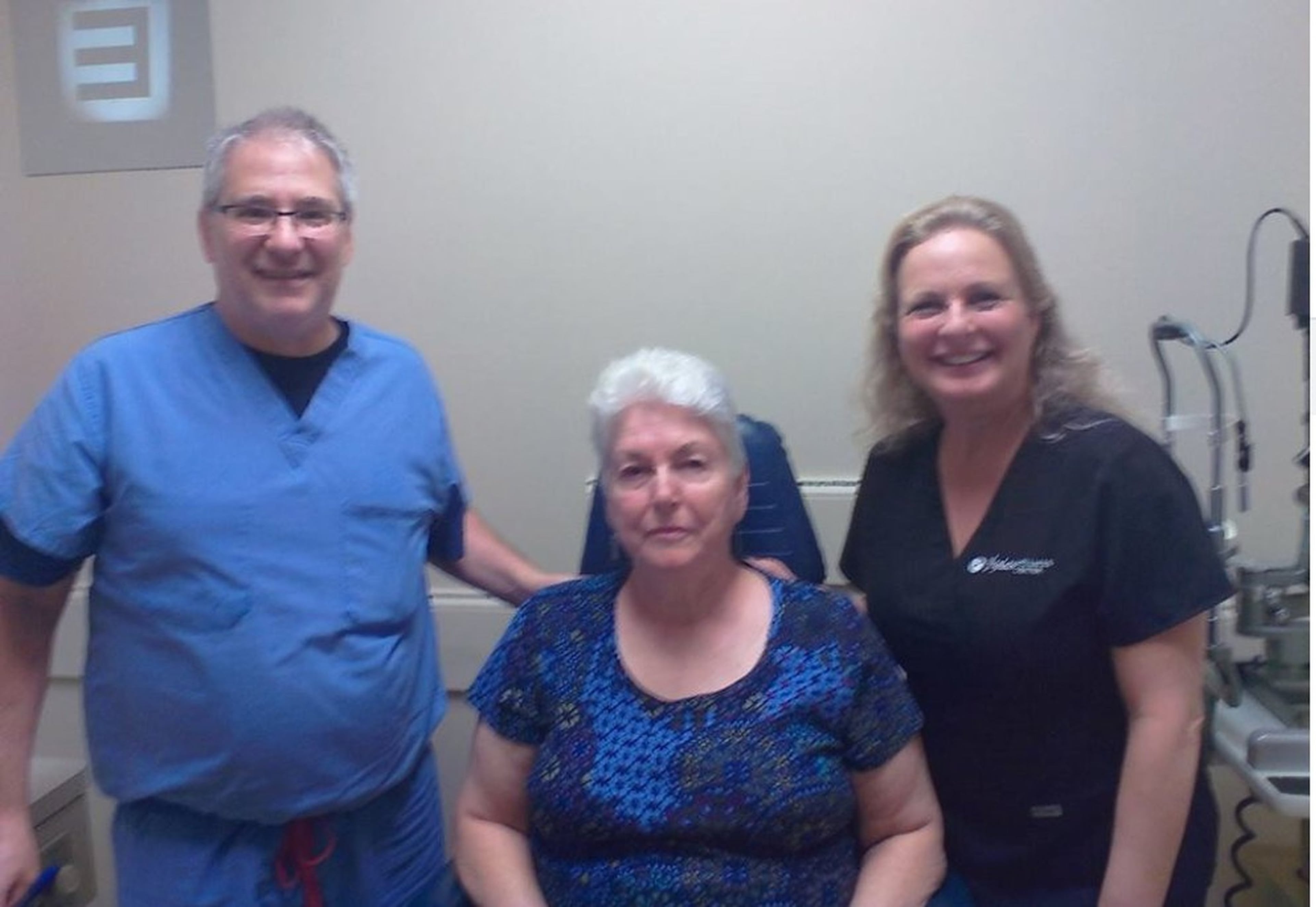 In a photo posted on Facebook, Doris Tyler is flanked by retinal surgeon Robert Halpern (left) and Dr. Jamie Walraven at Walraven's clinic. Weeks after her stem cell procedure, Tyler suffered retinal detachments in both of her eyes, leaving her blind. (Facebook)