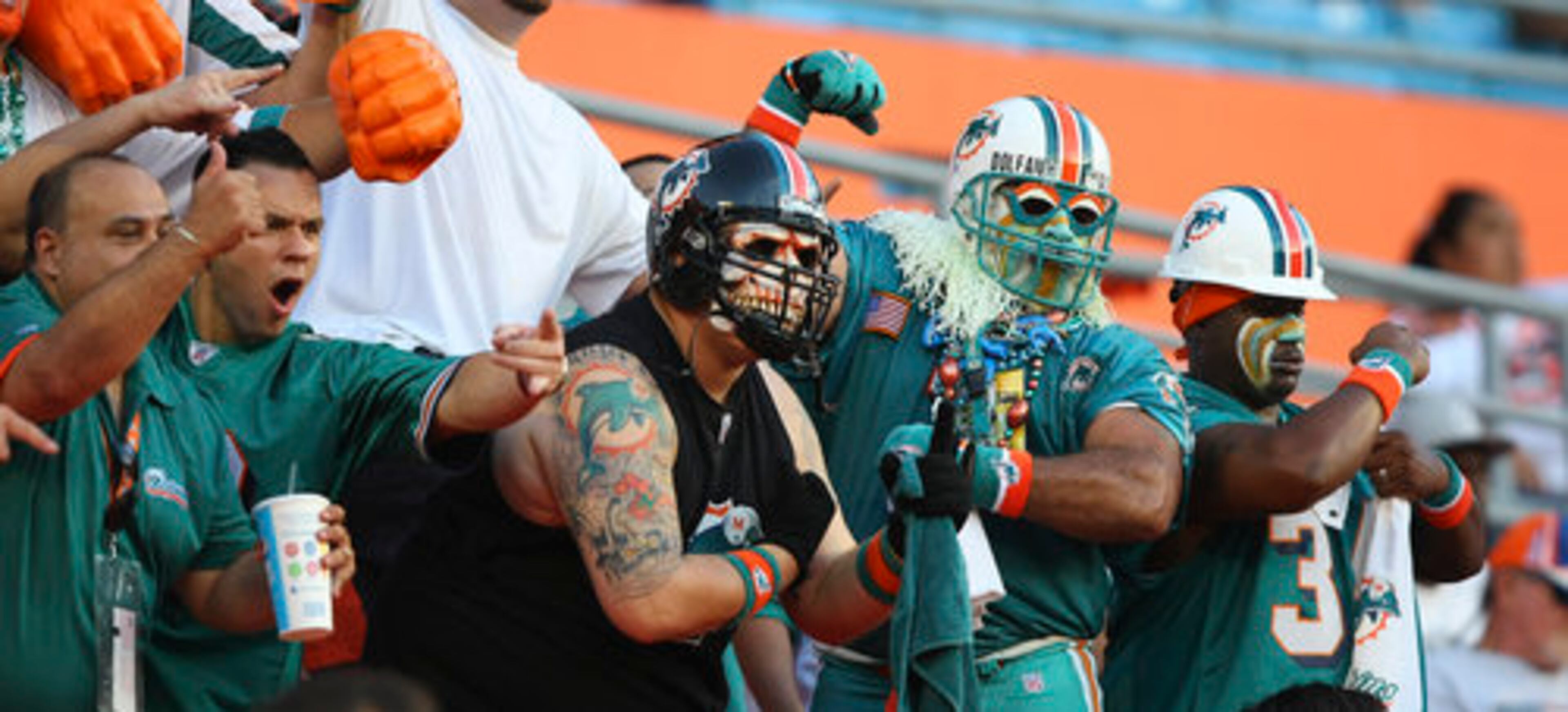 Miami Dolphins fans cheer for the Dolphins during first quarter NFL preseason football action against the Atlanta Falcons in Miami, Friday, Aug. 27, 2010.