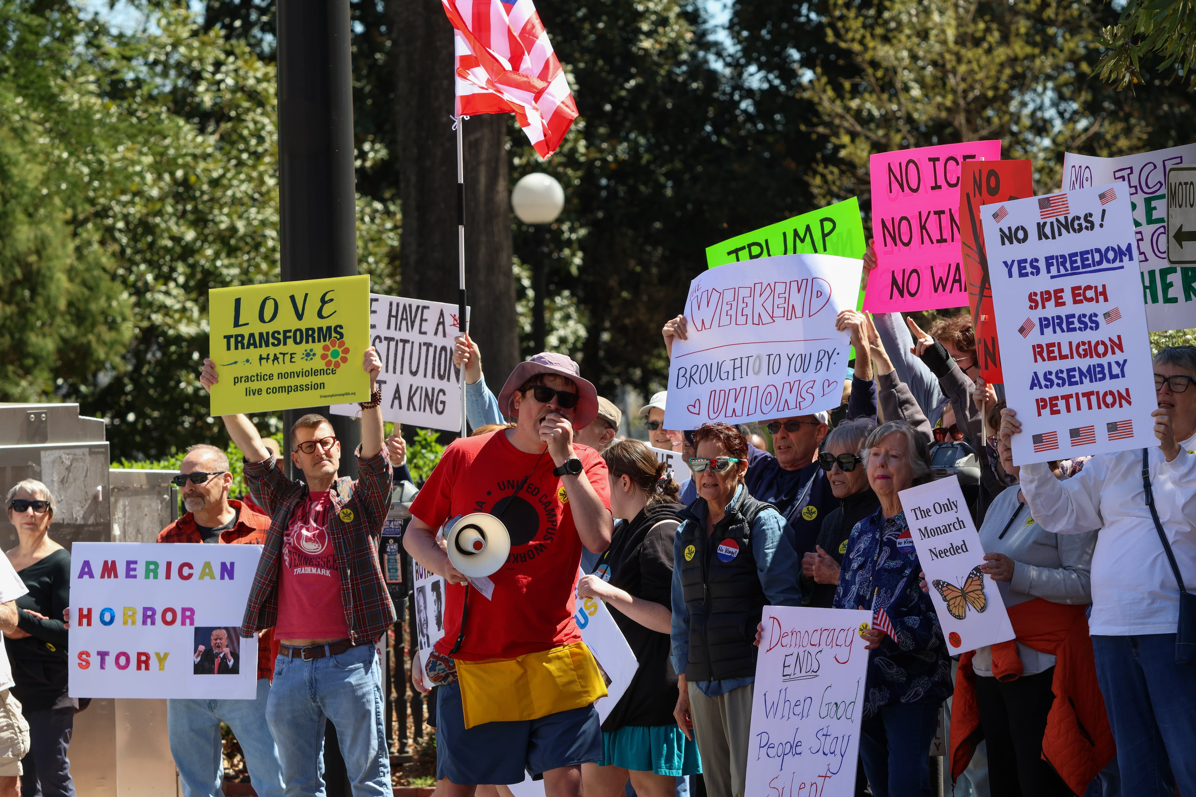 People protest near UGA’s Arch in Athens on Saturday, March 28, 2026. Protesters gathered in 10 different locations around Georgia’s Congressional District 10, leading up to a “Democracy Fair” at Athens’ Bishop Park as part of a nationwide day of “No Kings” demonstrations. Organizers estimate that a few thousand people participated, many of them first-time protesters. (C.J. Bartunek for the AJC)