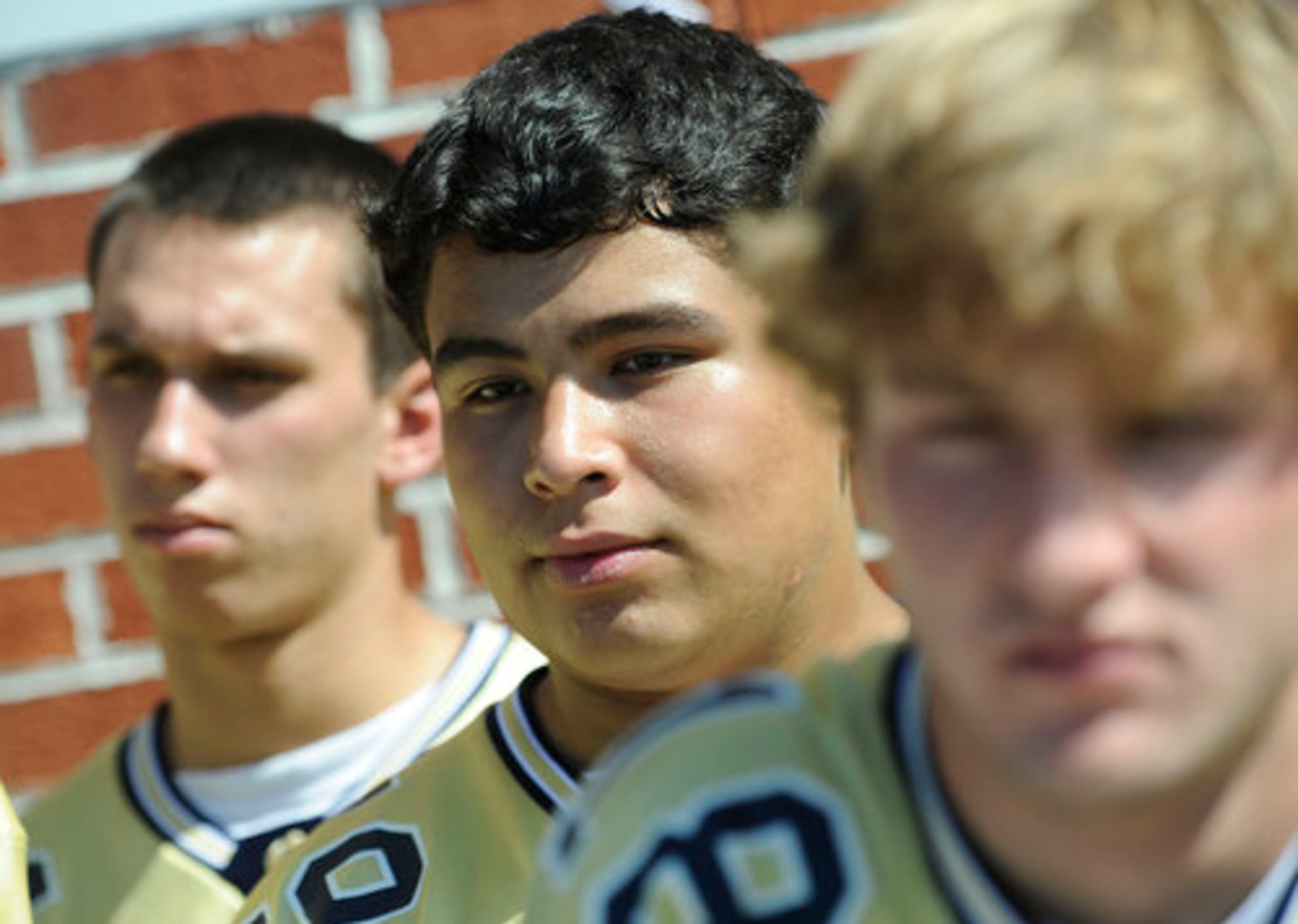From left, St. Pius X players Michael Pagouga, 17, Sean Espinosa, 18, and Brian Gee, 17, listen during the service.