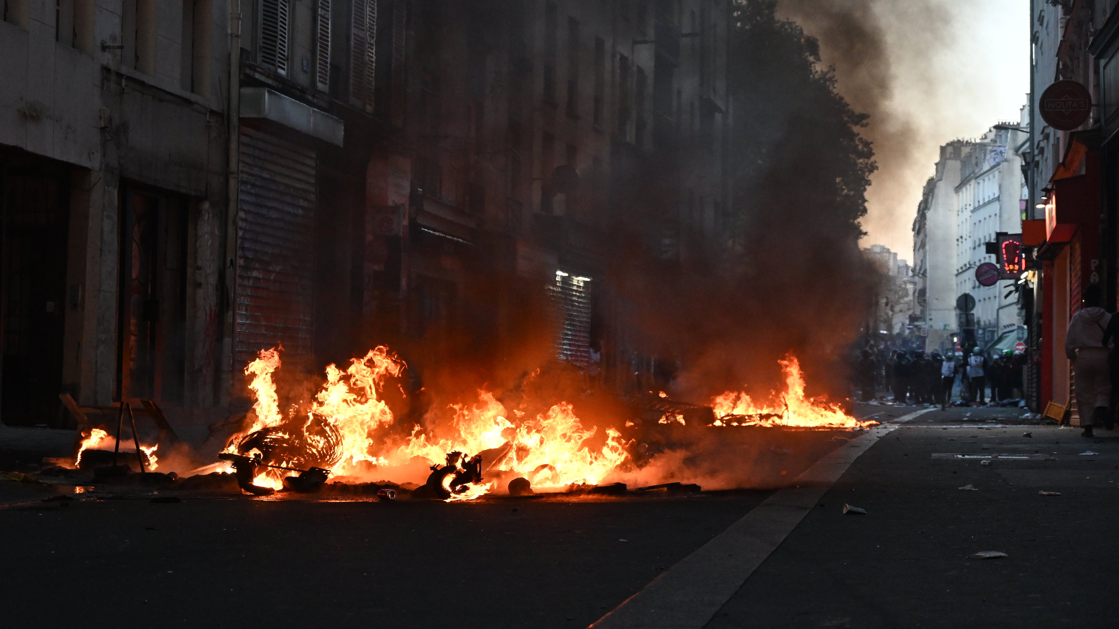 Trash burns during clashes between protestors and police officers during a demonstration against rising living costs, joining students' grievances, in Paris, Sunday, Oct. 18, 2026. (AP Photo/Emma Da Silva)