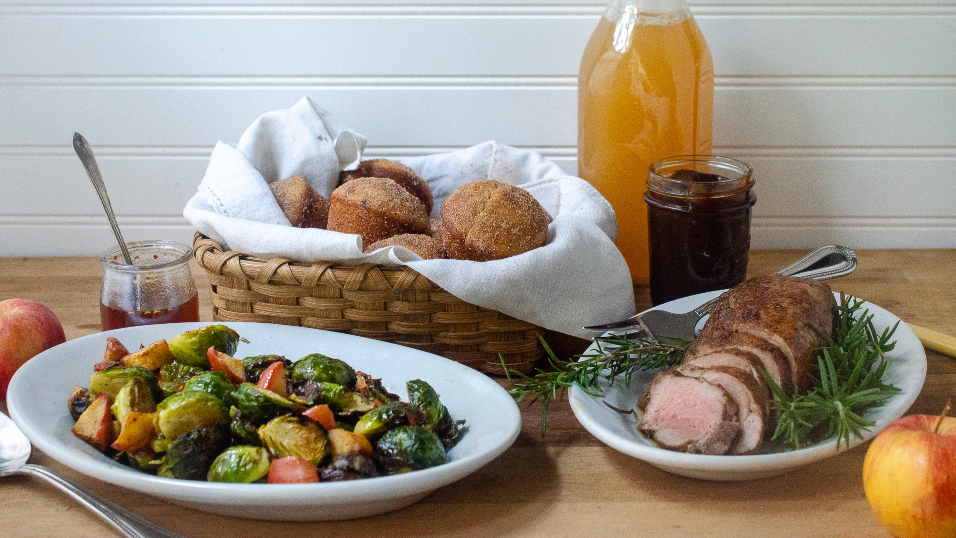 Apple cider adds fall flavors to this trio of recipes. From left: Apple Cider Hot Honey Reduction with Brussels Sprouts and Apples, Apple Cider Doughnut Muffins and Spiced Apple Cider Maple Pork Tenderloin. (Virginia Willis for The Atlanta Journal-Constitution)