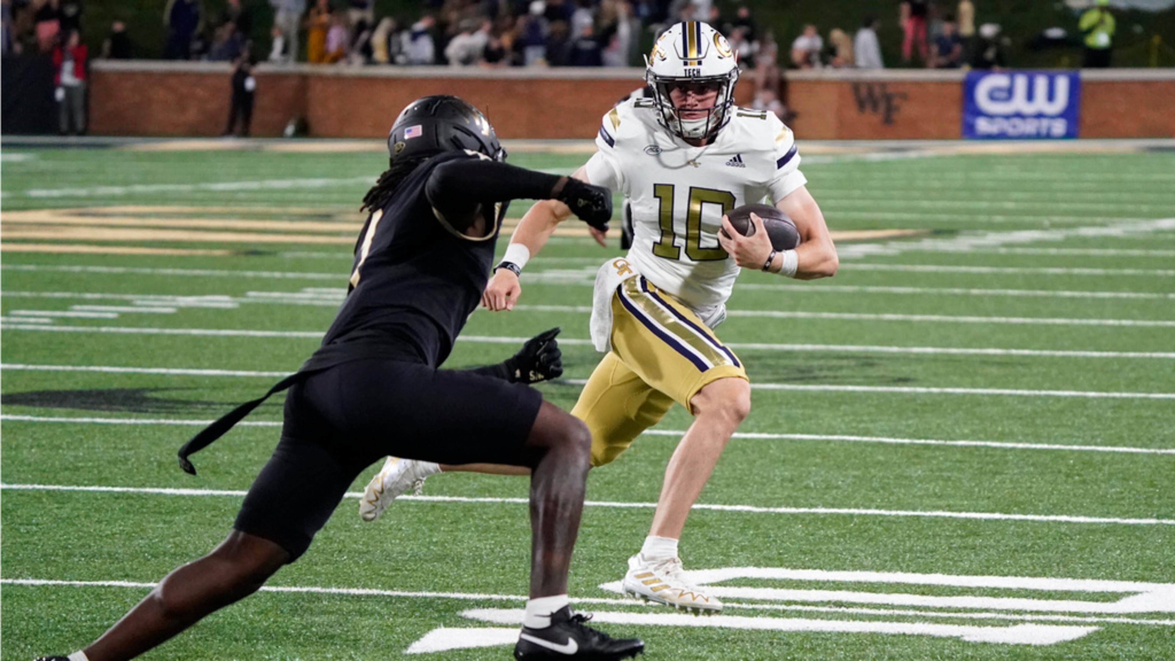 Georgia Tech quarterback Haynes King (10) tries to run past Wake Forest defensive back Caelen Carson (1) during the second half of an NCAA college football game in Winston-Salem, N.C., Saturday, Sept. 23, 2023. (AP Photo/Chuck Burton)