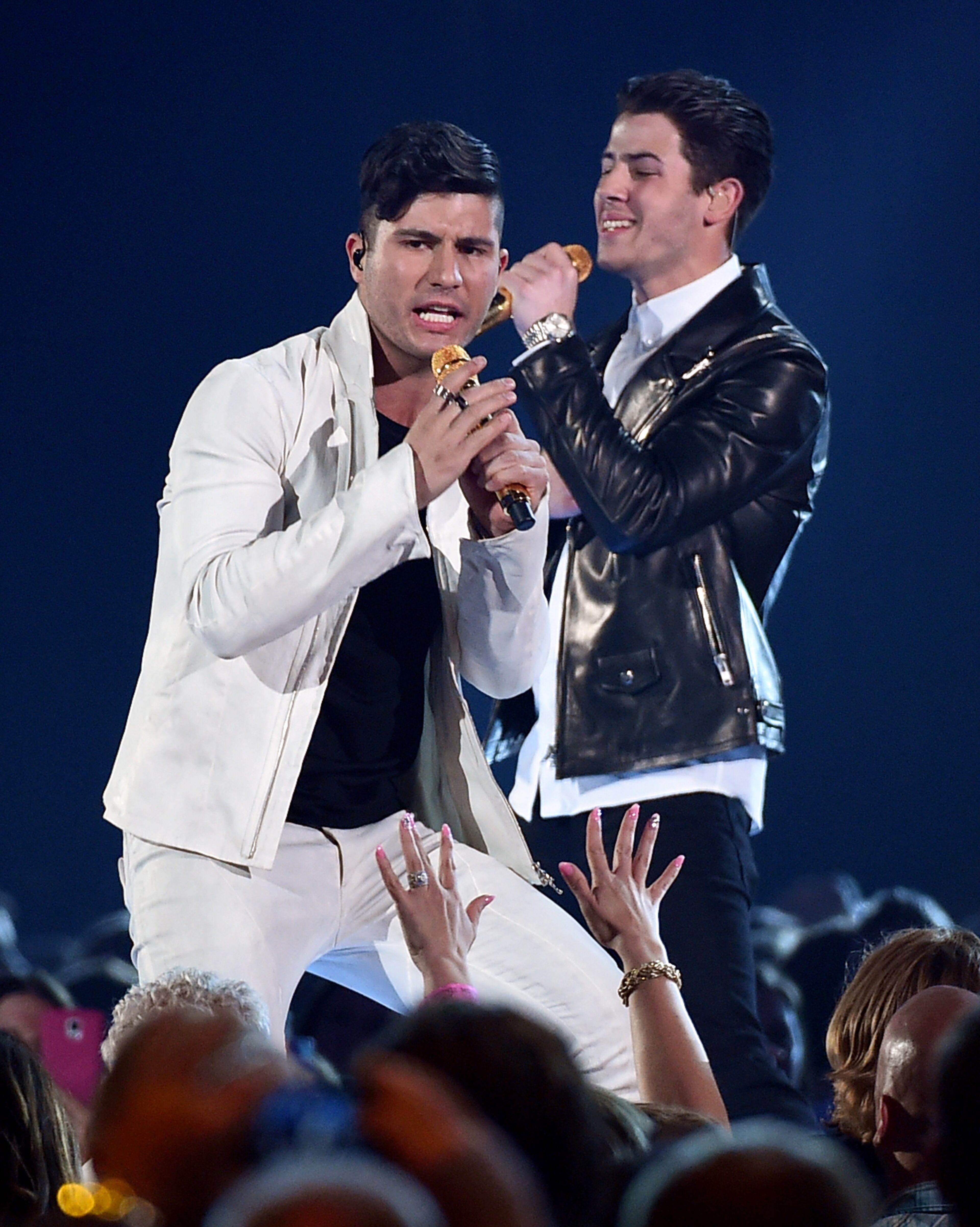 Musician Dan Smyers (L) of Dan + Shay and singer/actor Nick Jonas perform onstage during the 50th Academy Of Country Music Awards at AT&T Stadium on April 19, 2015 in Arlington, Texas. (Photo by Ethan Miller/Getty Images for dcp)