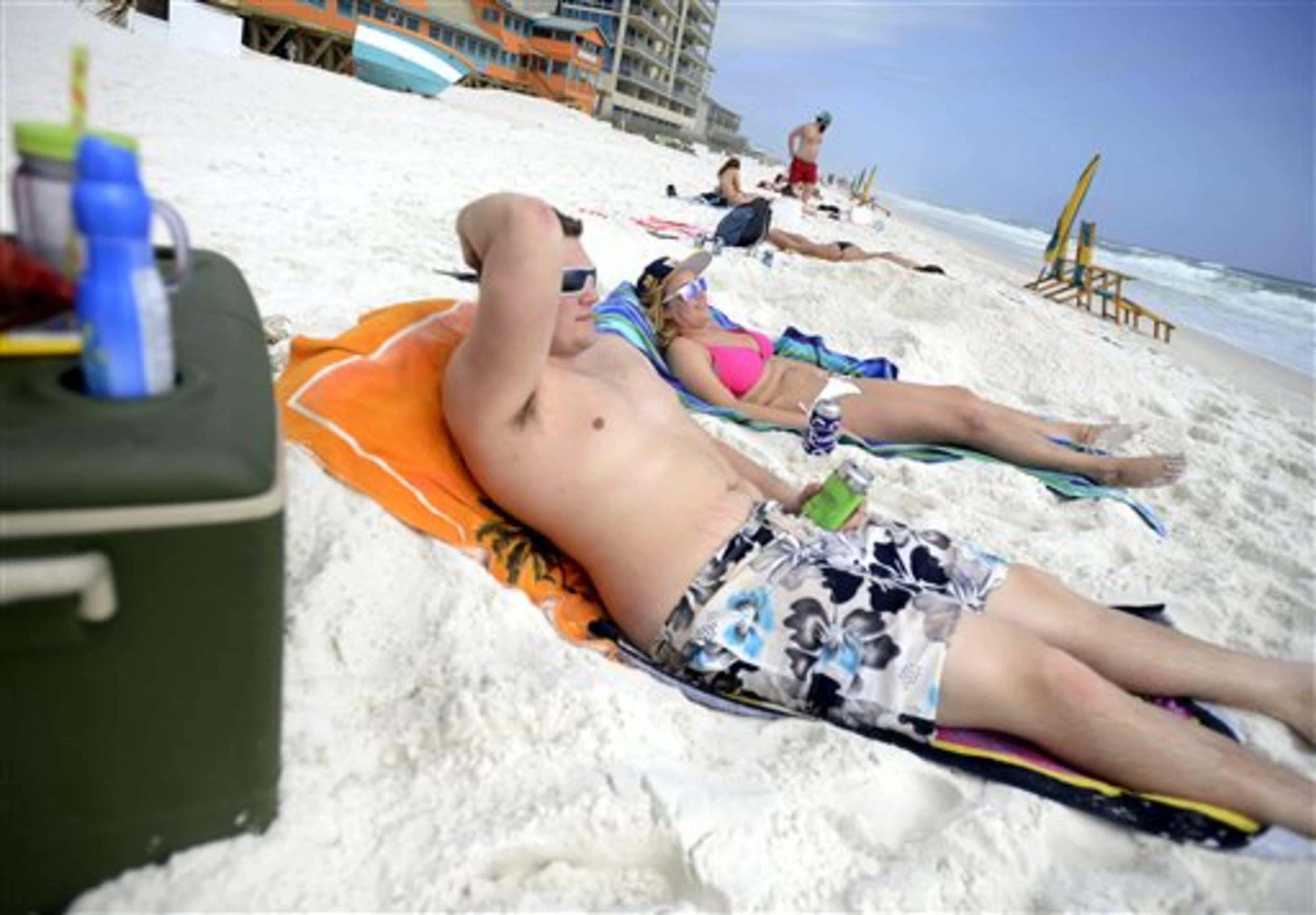 Hunter Mason, left, and Olivia Murat, on spring break from the University of Indianapolis, relax on the beach Tuesday March 5, 2013 in Destin, Florida. Spring breakers from around the country have started to arrive in Northwest Florida, thousands more are expected to arrive in the coming weeks. (AP Photo/Northwest Florida Daily News, Nick Tomecek)
