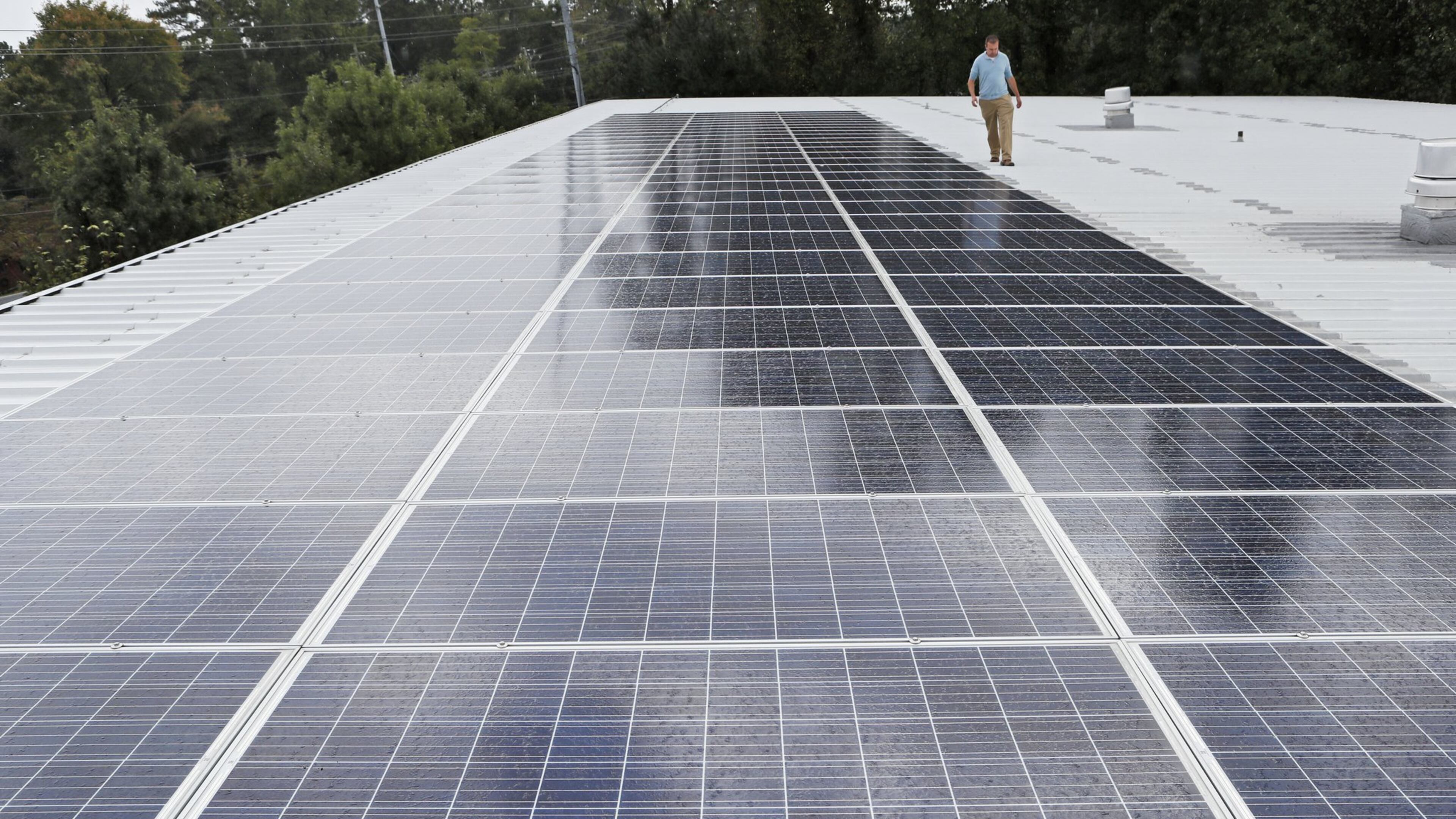 Scott Starowicz, SAE’s chief financial officer, walks past the school’s solar panel array. The pre-K-8 school in Mableton is believed to be the first elementary school in the state with plans to be powered 100% by solar energy. Sustainability efforts are integrated into the school’s curriculum. BOB ANDRES / ROBERT.ANDRES@AJC.COM