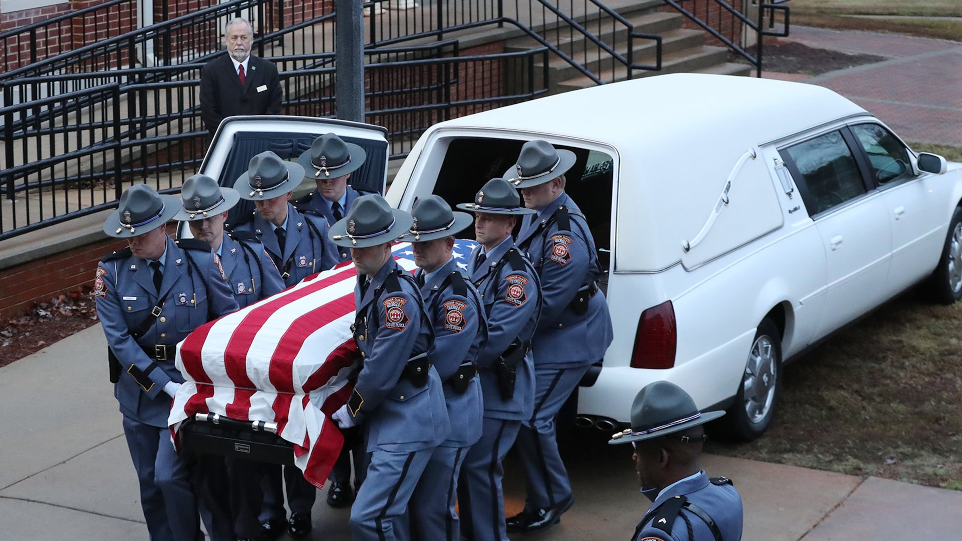 An honor guard escorts Georgia Southwestern State University campus police officer Jody Smith into the Storm Dome for his funeral service at the university on Wednesday, Dec. 14, 2016, in Americus. Officer Smith and Americus police officer Nicholas Ryan Smarr, best friends, were killed responding to a domestic dispute. (Curtis Compton/ccompton@ajc.com)