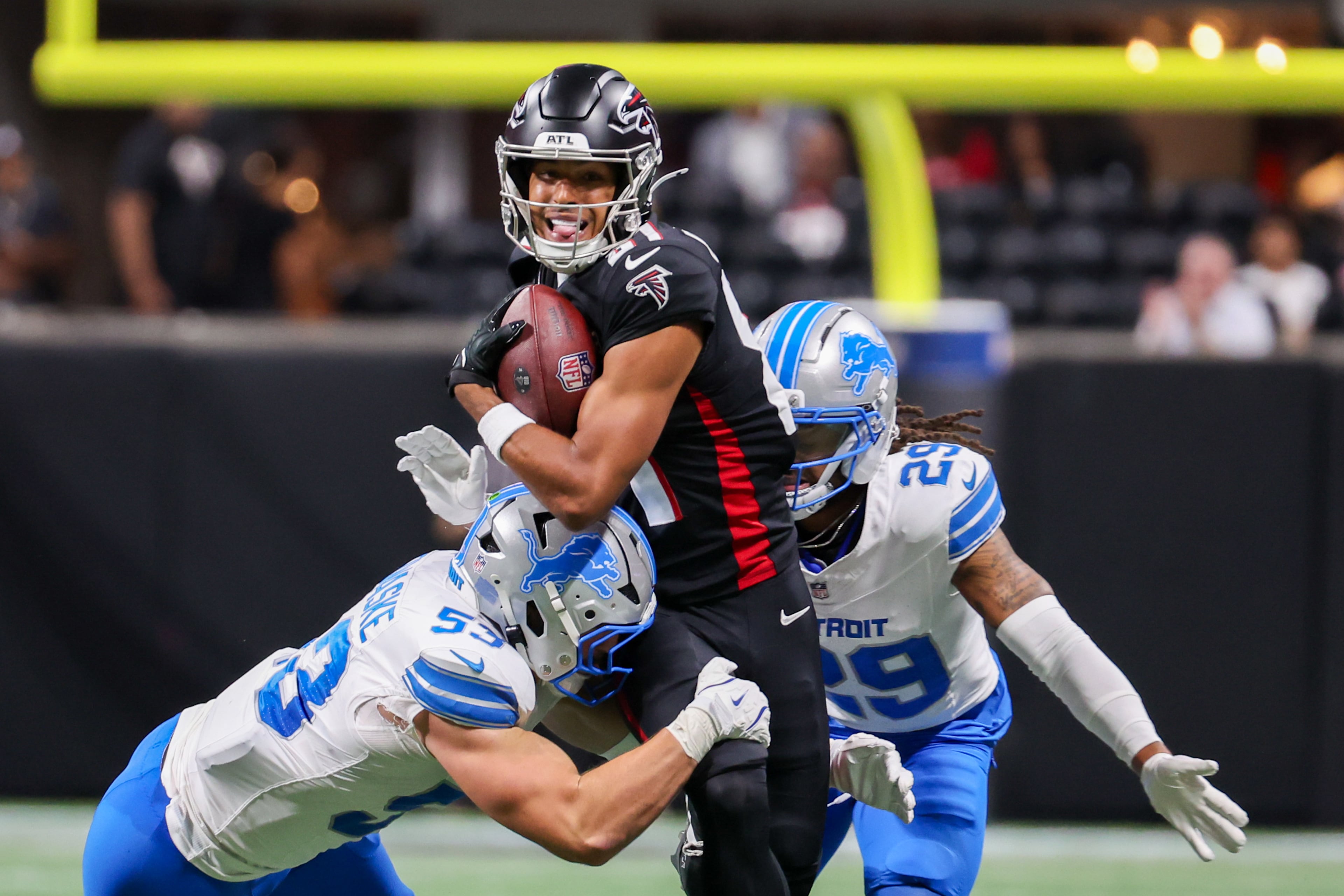 Atlanta Falcons wide receiver Dylan Drummond (81) runs under pressure from Detroit Lions linebacker Trevor Nowaske (53) and Detroit Lions cornerback Avonte Maddox (29) during the first half of an NFL preseason game against the Detroit Lions at Mercedes-Benz Stadium in Atlanta on Friday, August 8, 2025. (Arvin Temkar / AJC)
