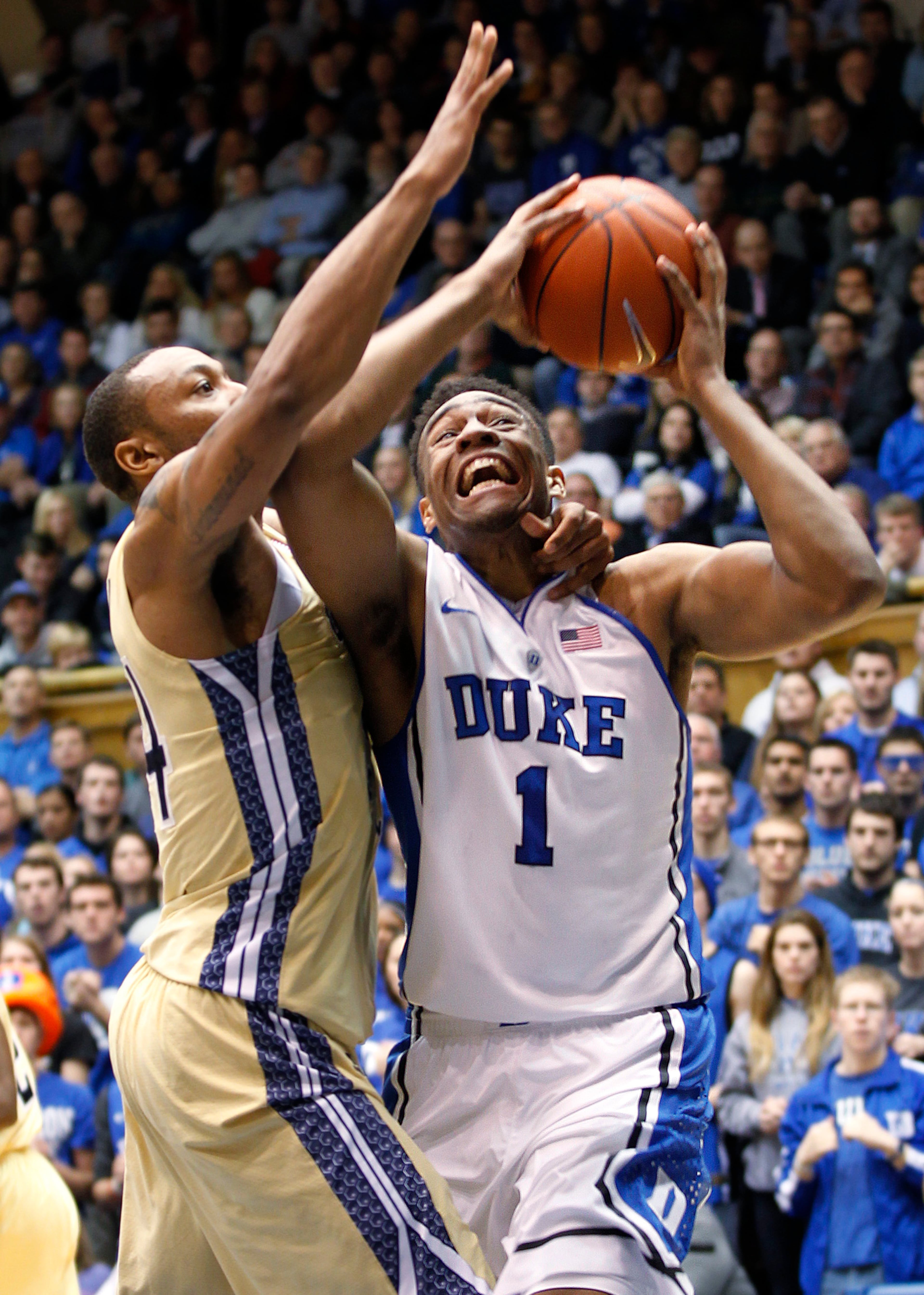 Duke's Jabari Parker, right, is fouled by Georgia Tech's Kammeon Holsey during the first half of an NCAA college basketball game in Durham, N.C., Tuesday, Jan. 7, 2014.