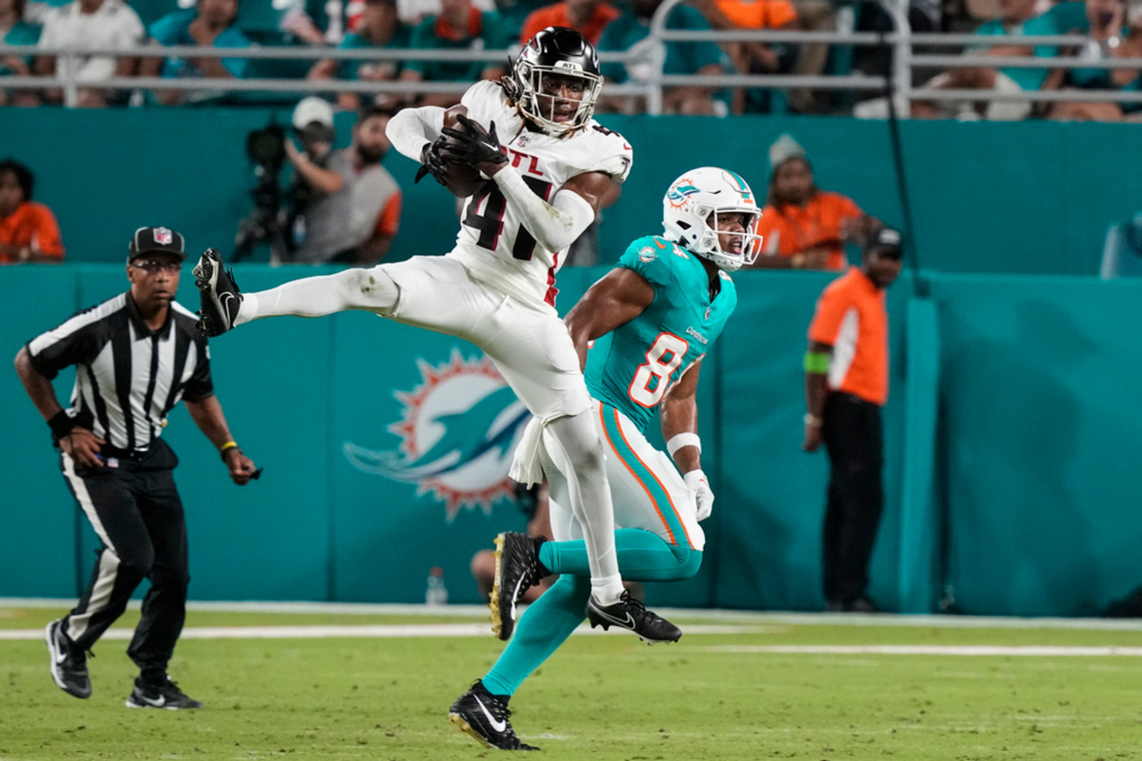 Atlanta Falcons safety Lukas Denis (41) intercepts a pass intended for Miami Dolphins tight end Elijah Higgins (84) in the second half of a preseason NFL football game, Friday, Aug. 11, 2023, in Miami Gardens, Fla. (AP Photo/Marta Lavandier)