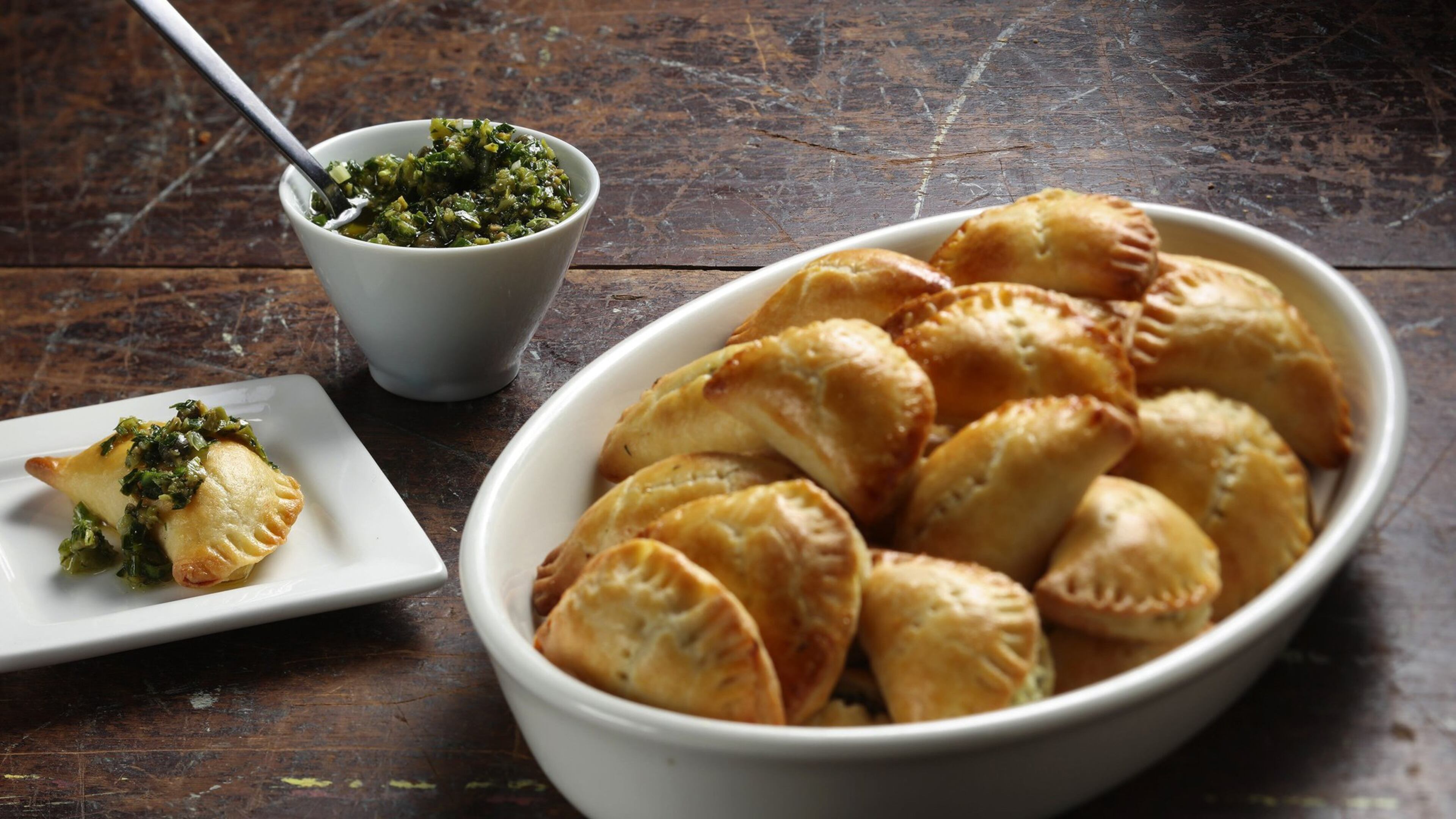 Cheese turnovers have cream cheese in the dough, plus a filling of farmer cheese, fresh arugula, ramps and dill. (Shannon Kinsella / food styling) (Abel Uribe/Chicago Tribune/TNS)