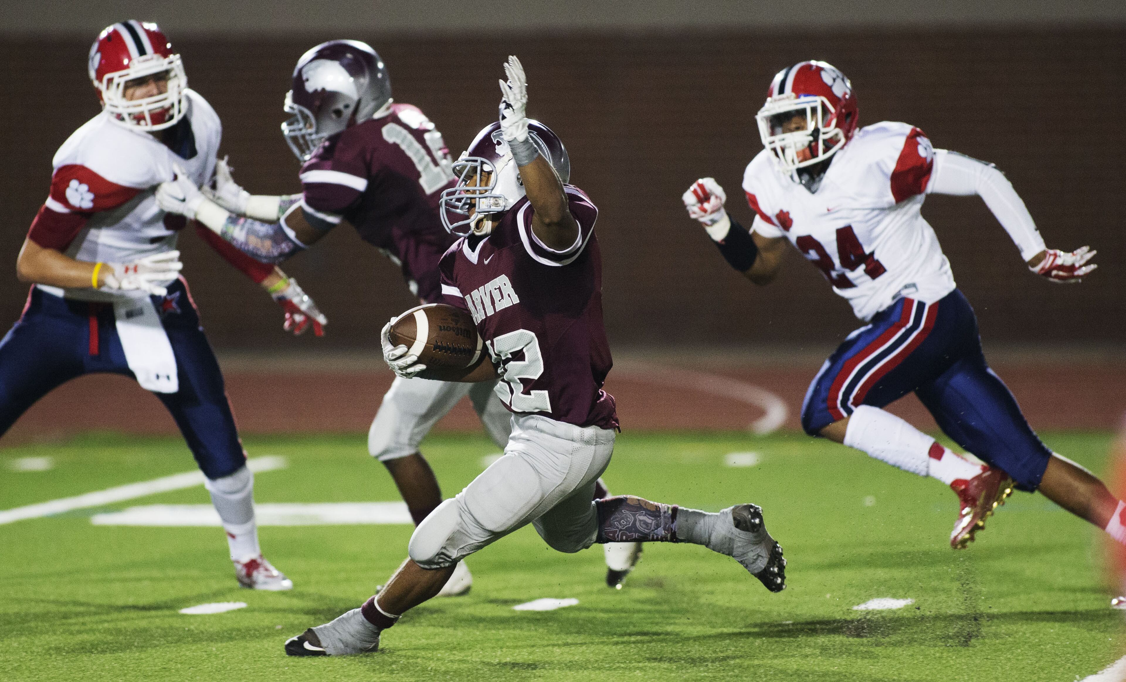 Carver's # 22 Gregory Payton (center) runs for a first quarter touchdown against the Dunwoody Wildcats varsity football team at Lakewood Stadium in Atlanta on Friday Sept. 11th, 2015. Carver was ahead 38-0 in the second quarter. (Photo by Phil Skinner)