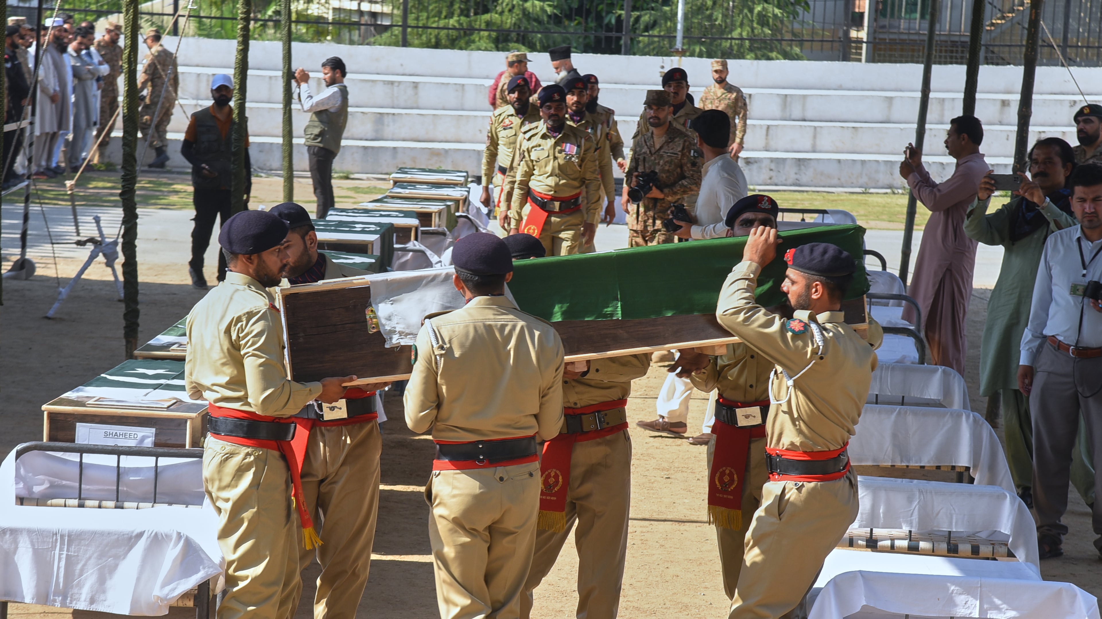 Army soldiers carry a flag-wrapped casket of military personnel, killed in the Wednesday's helicopter crashed, during a funeral prayer, in Muzaffarabad, the capital of Pakistan-administered Kashmir, Thursday, June 11, 2026. (AP Photo/M.D. Mughal)
