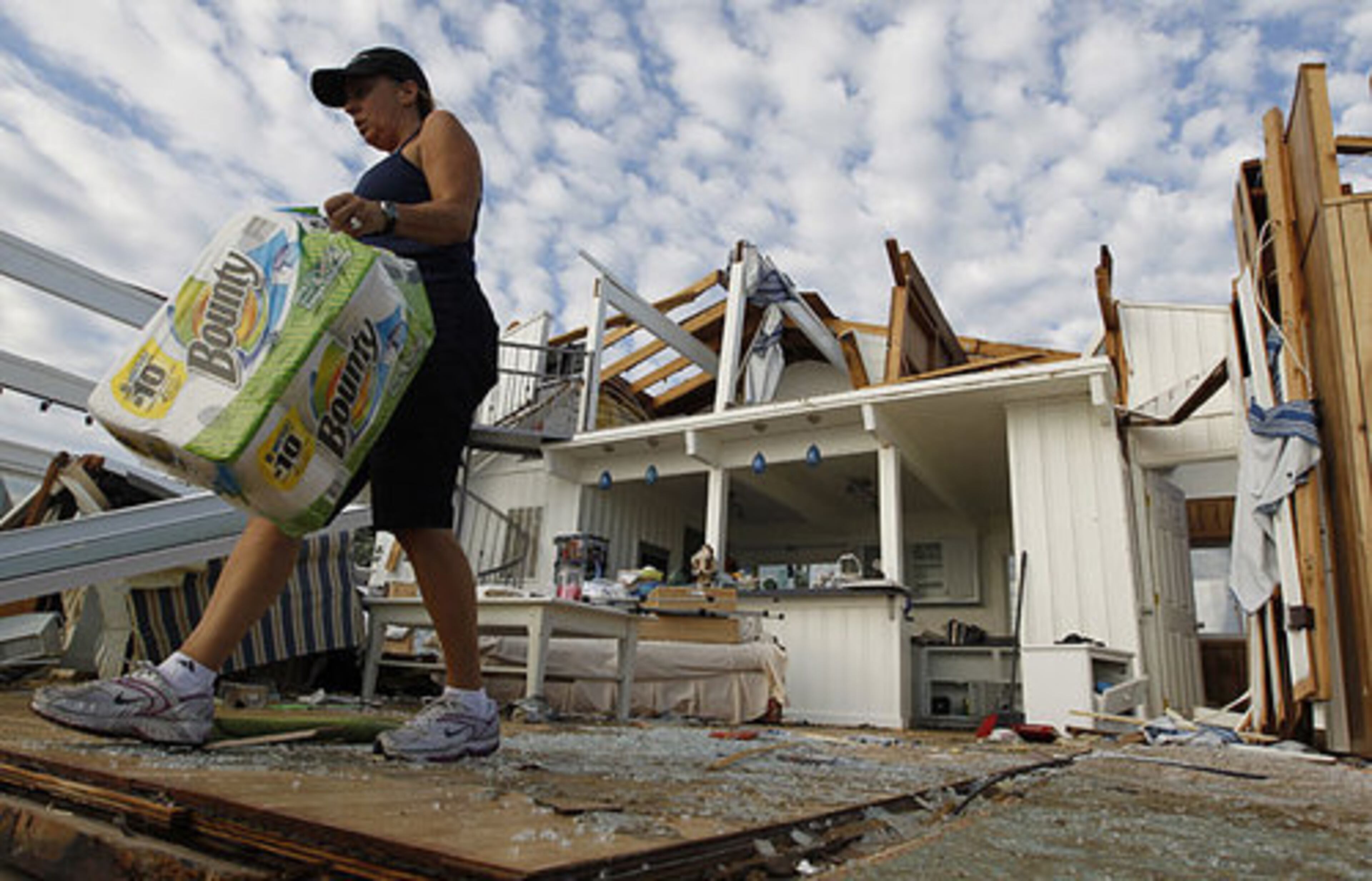 Denise Robinson clears out her destroyed beach home in the Sandbridge area of Virginia Beach after Hurricane Irene hit Virginia Beach, Va., Sunday, Aug. 28, 2011.