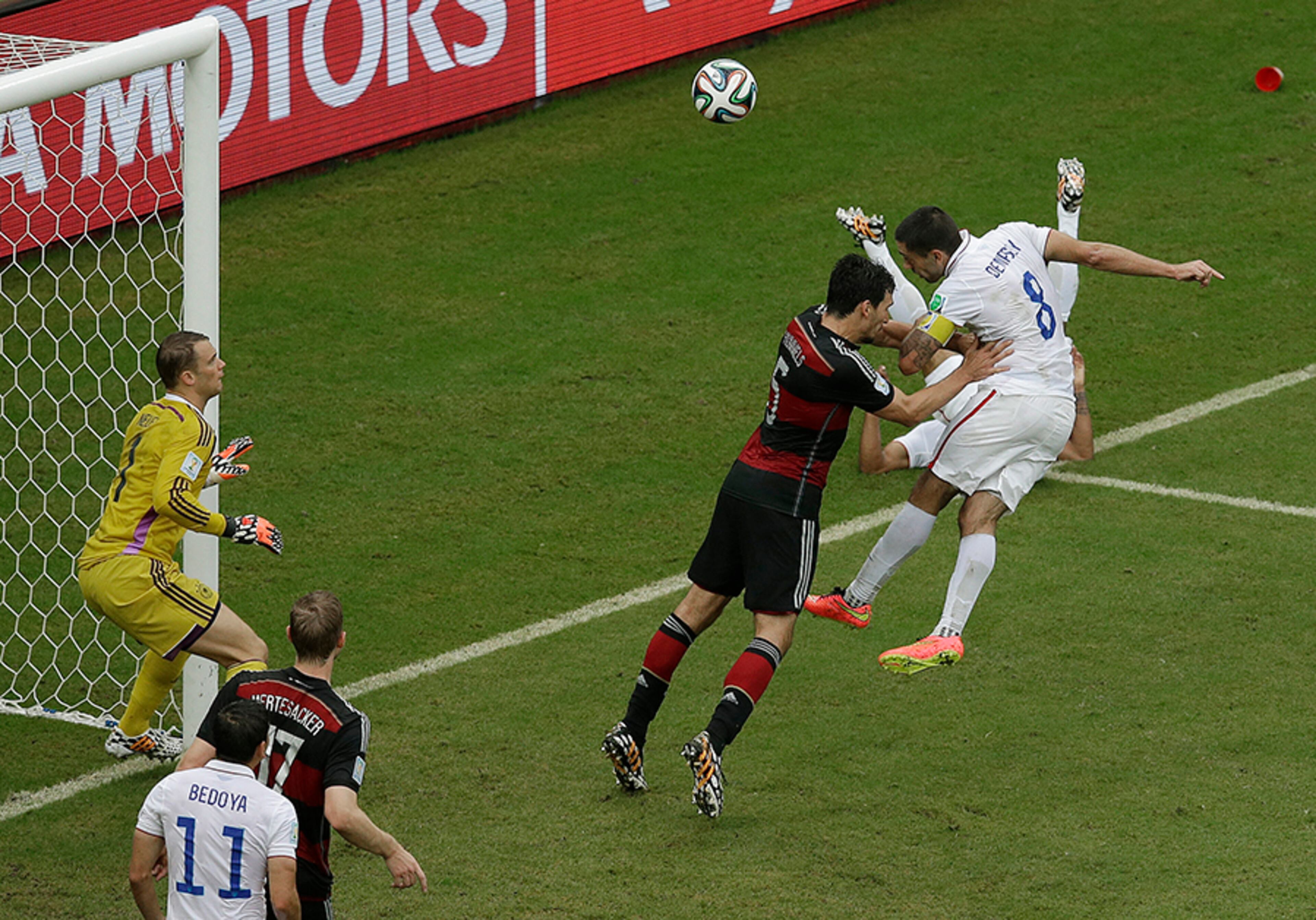 United States' Clint Dempsey heads the ball toward the goal past Germany's Mats Hummels and Germany's goalkeeper Manuel Neuer near the end of the match between the USA and Germany at the Arena Pernambuco in Recife, Brazil, Thursday, June 26, 2014. The ball went high and did not score. The U.S. lost 1-0, but advanced to the second stage of the World Cup.