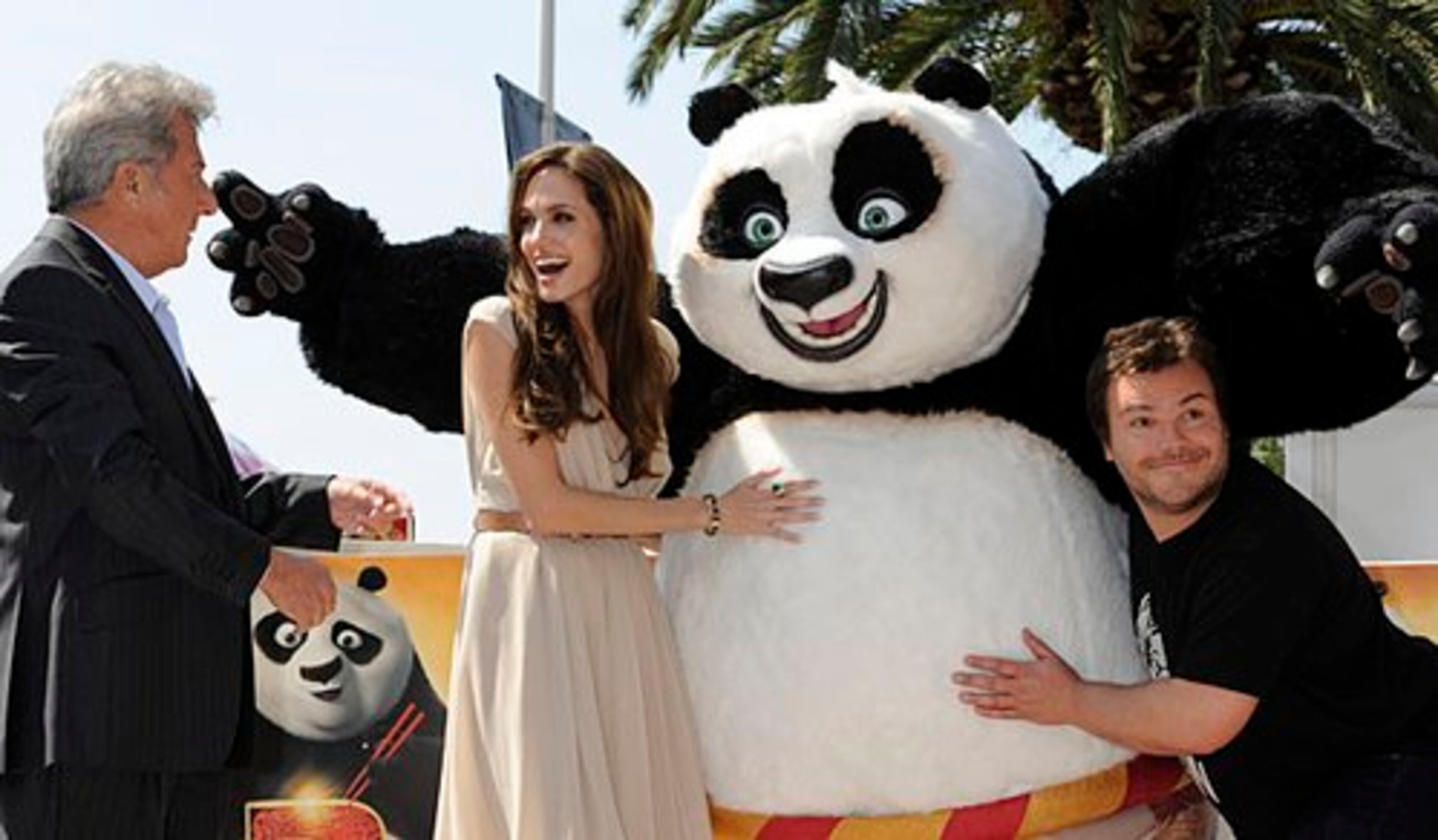 Actor Dustin Hoffman (left) speaks with actors Angelina Jolie and Jack Black as they pose with a person in a giant panda costume during a photo call for "Kung Fu Panda 2" at the 64th international film festival, in Cannes, southern France, Thursday, May 12, 2011.