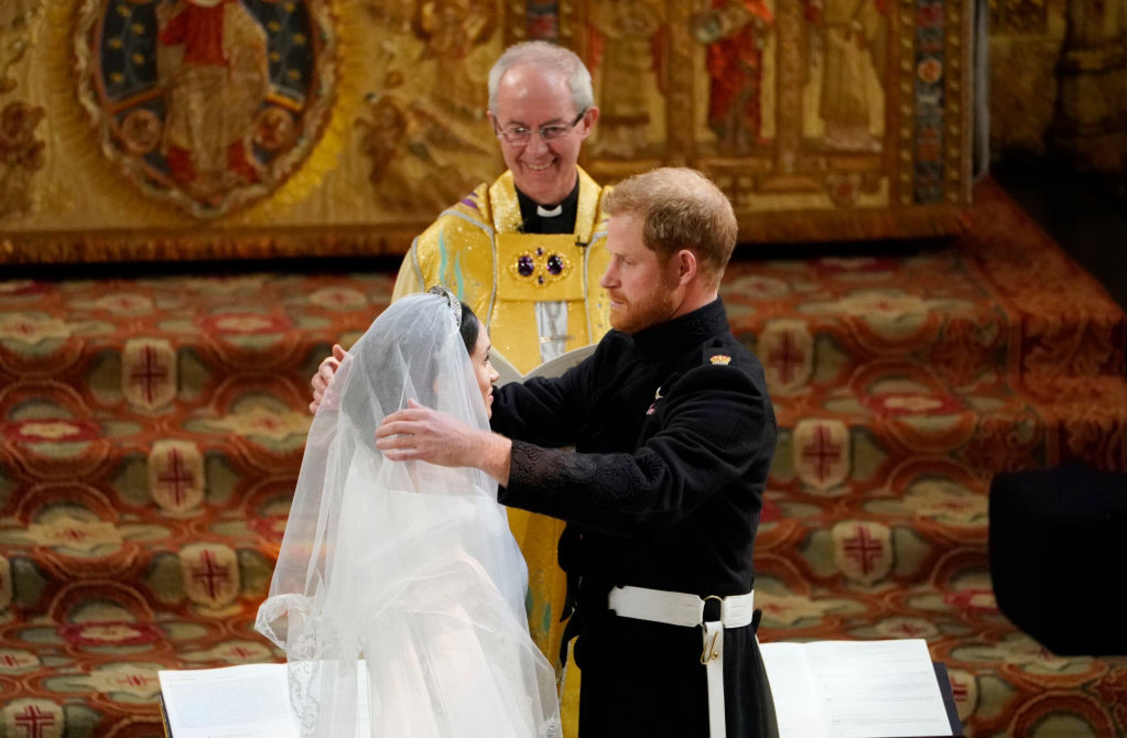 WINDSOR, UNITED KINGDOM - MAY 19: Prince Harry lifts the veil of Meghan Markle during their wedding ceremony in St George's Chapel at Windsor Castle on May 19, 2018 in Windsor, England. (Photo by Owen Humphreys - WPA Pool/Getty Images)