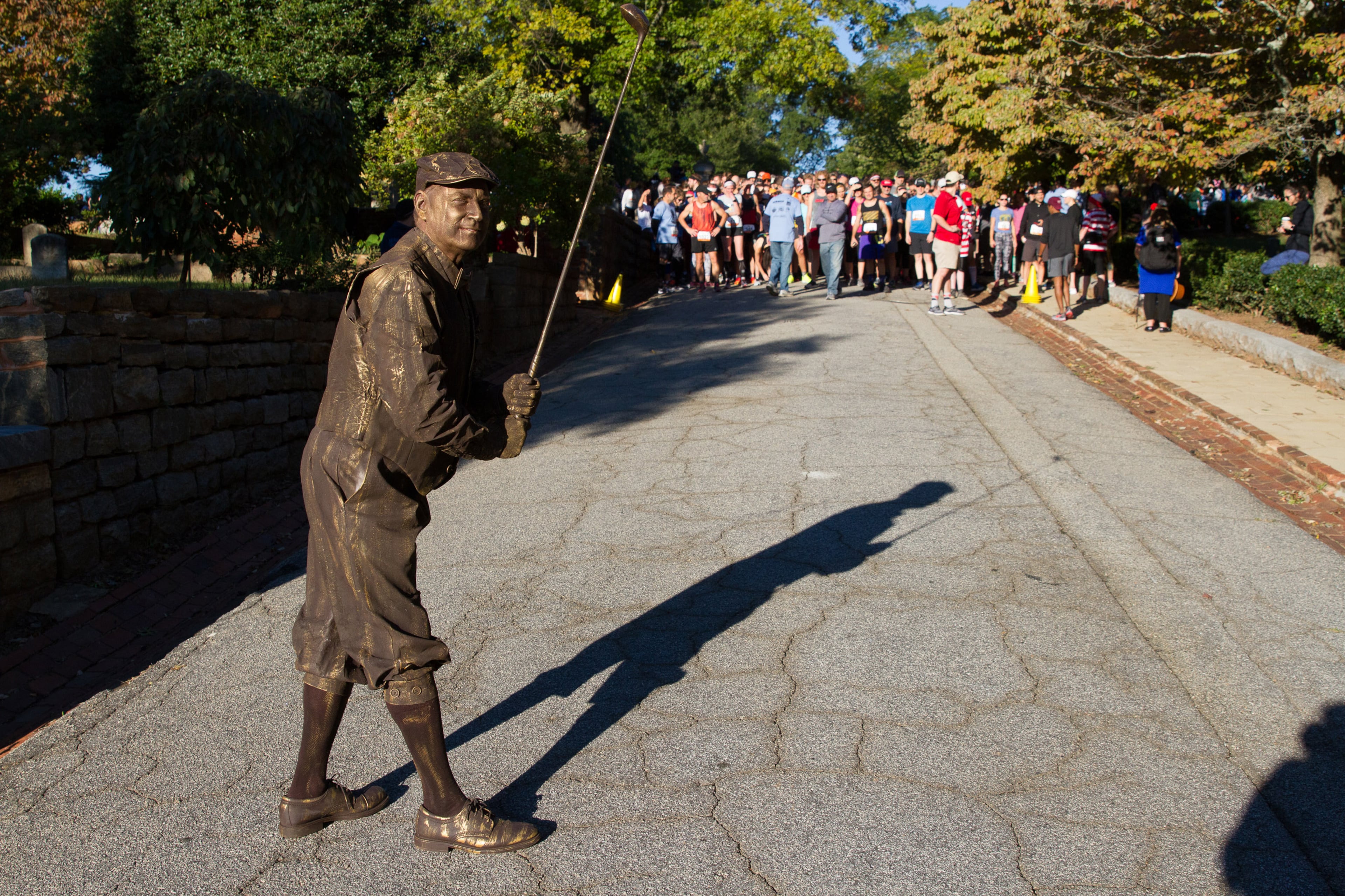 Bob Seymore (C), dressed up like a statue of golfer Bobby Jones, gets ready to start the 11th annual Run Like Hell 5K in Oakland Cemetery Saturday, October 13, 2018. STEVE SCHAEFER / SPECIAL TO THE AJC