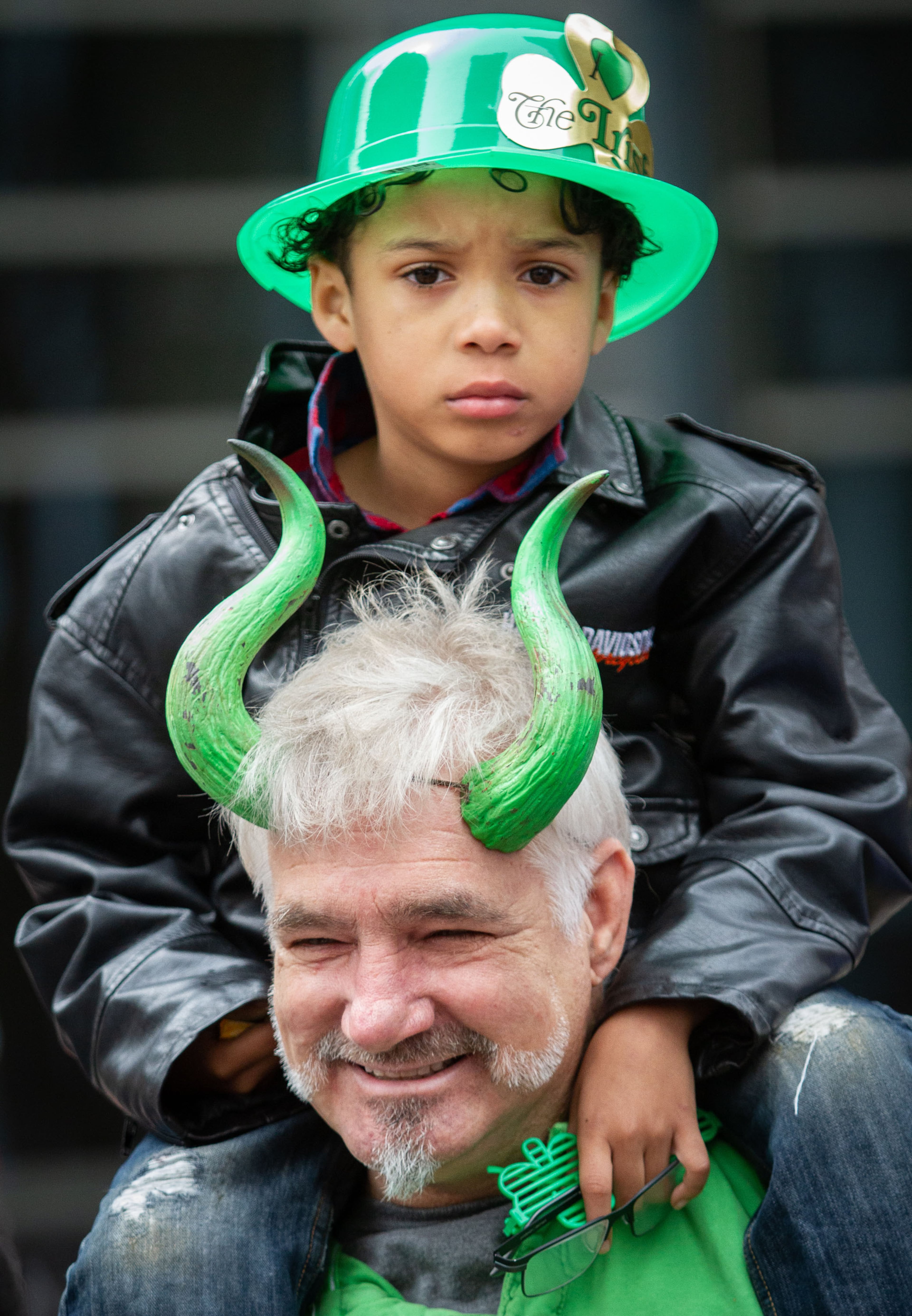 Richerd Benton and his grandson Richerd Jr. Benton watch the Atlanta St. Patrick's Parade head down Peachree Street on Saturday, March 16, 2019. (Photo: STEVE SCHAEFER / SPECIAL TO THE AJC)