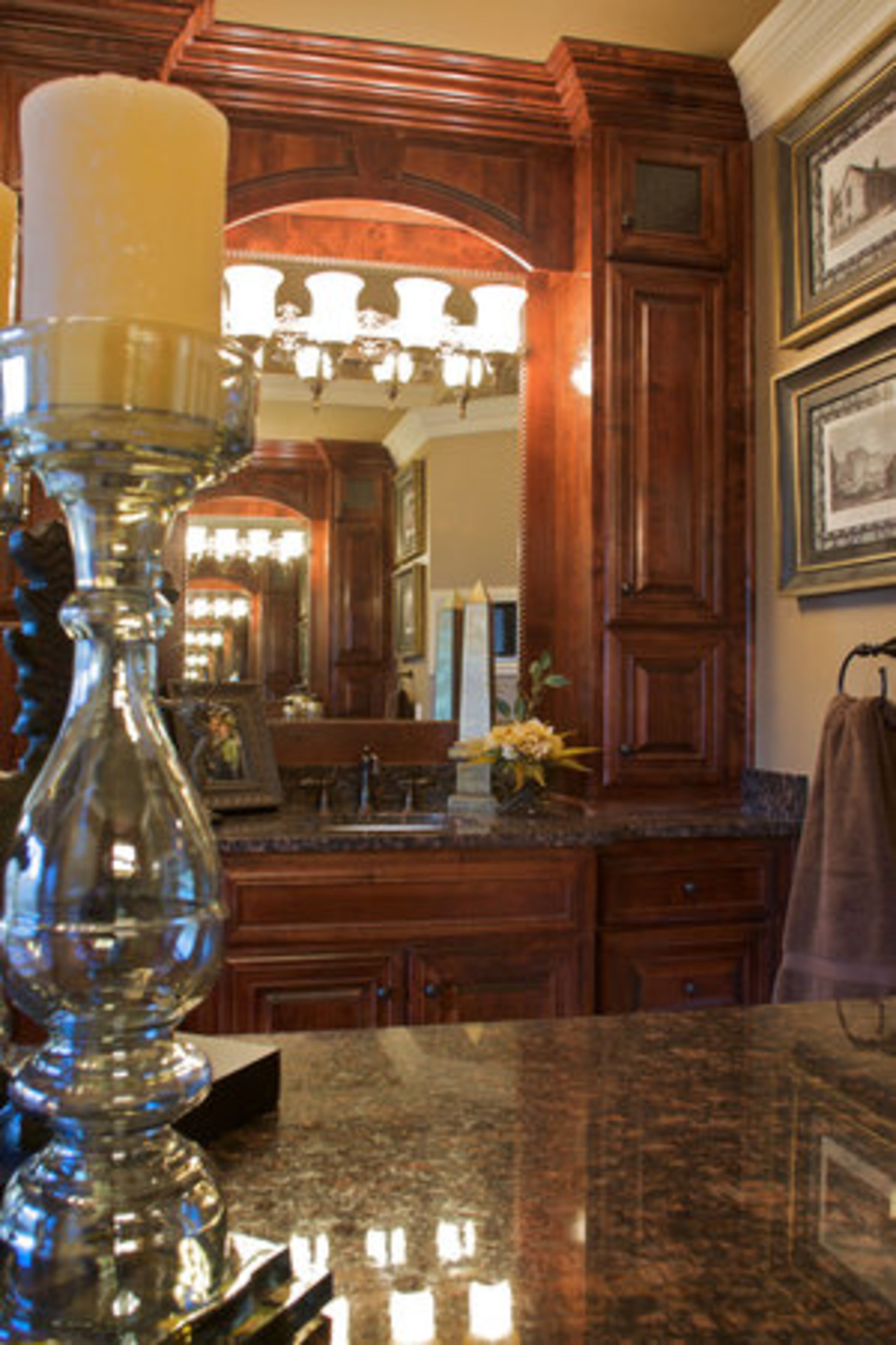 Granite counters and cherry cabinets adorn the regal master bathroom. The room is also fitted with a heated towel rack and wall-mounted television.