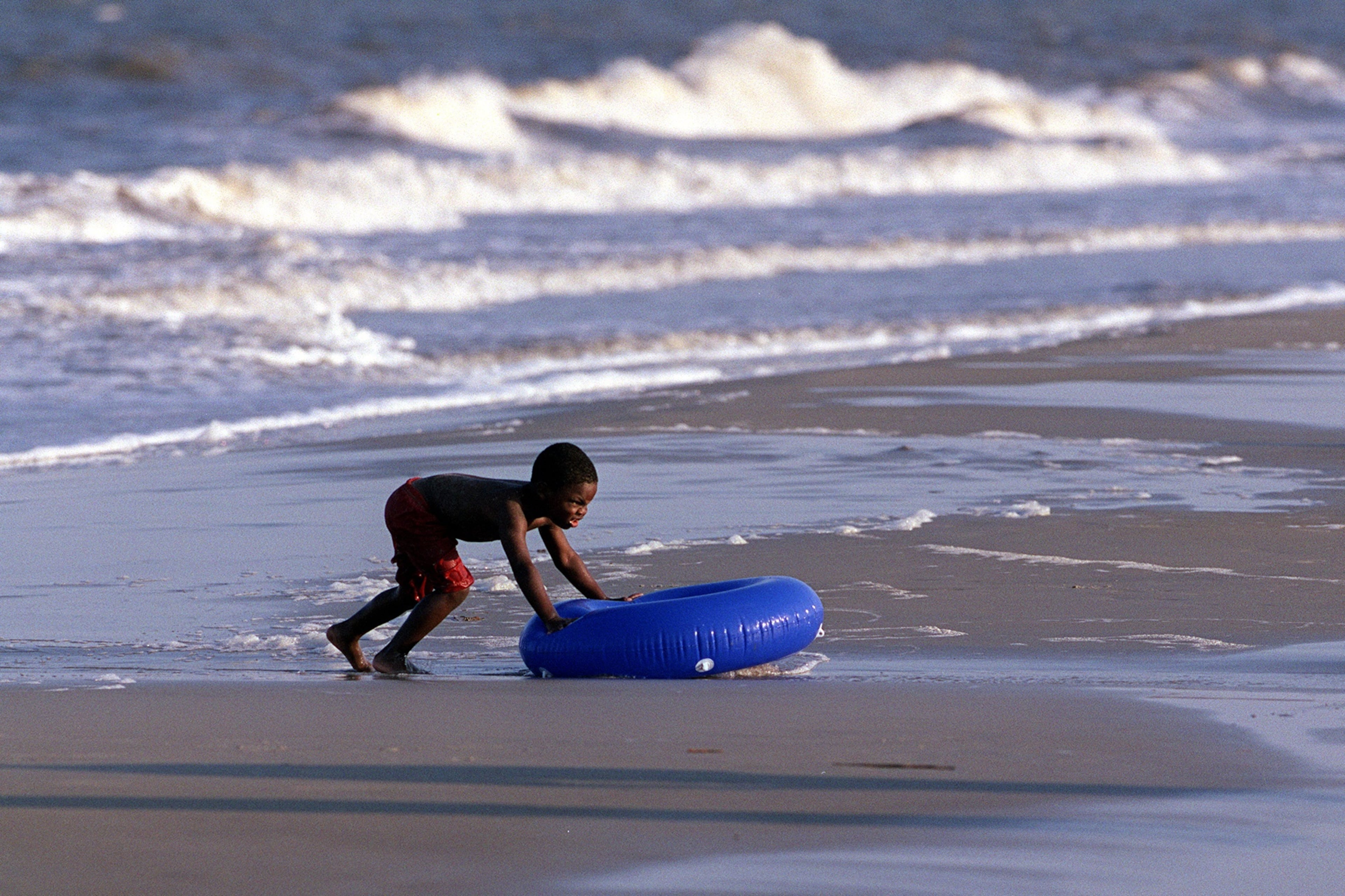 A boy plays in the surf in the Atlantic on Jekyll Island. (Louie Favorite/AJC 2001)