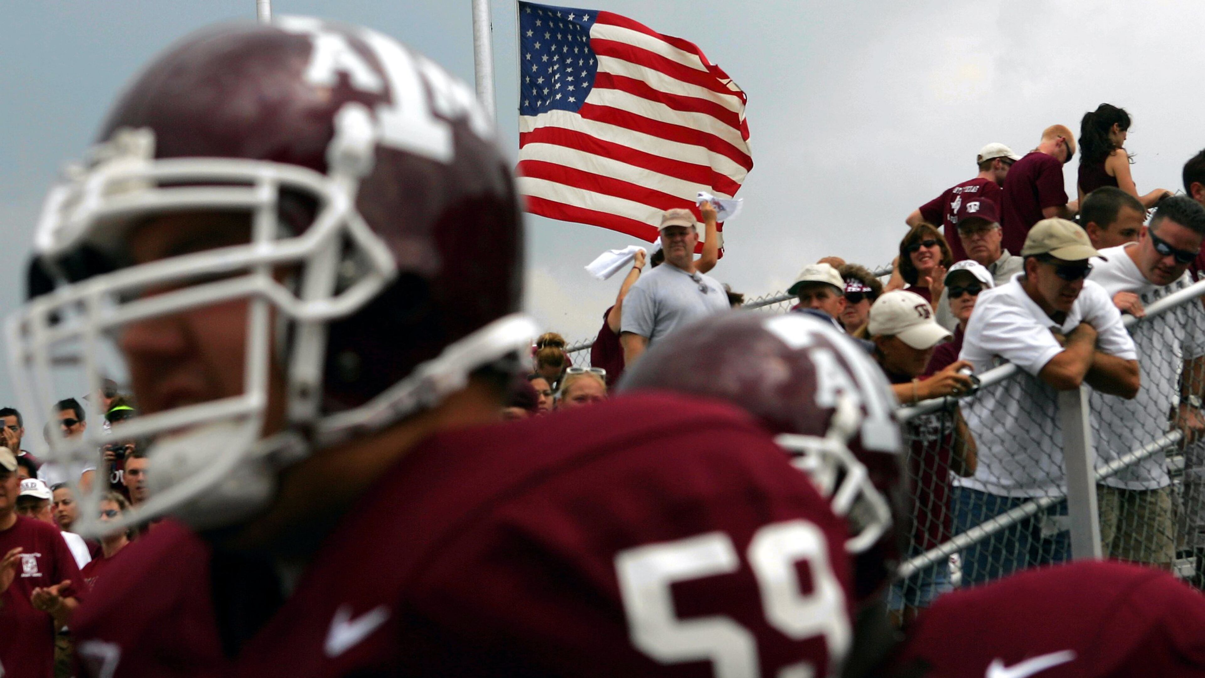 COLLEGE STATION, TX - SEPTEMBER 11: John David Nicholson of the Texas A&M University Aggies enters the field as the United States flag is raised at half mast in remembrance of the September 11 terrorist attack on September 11, 2004 at Kyle Field in College Station, Texas. (Photo by Ronald Martinez/Getty Images)