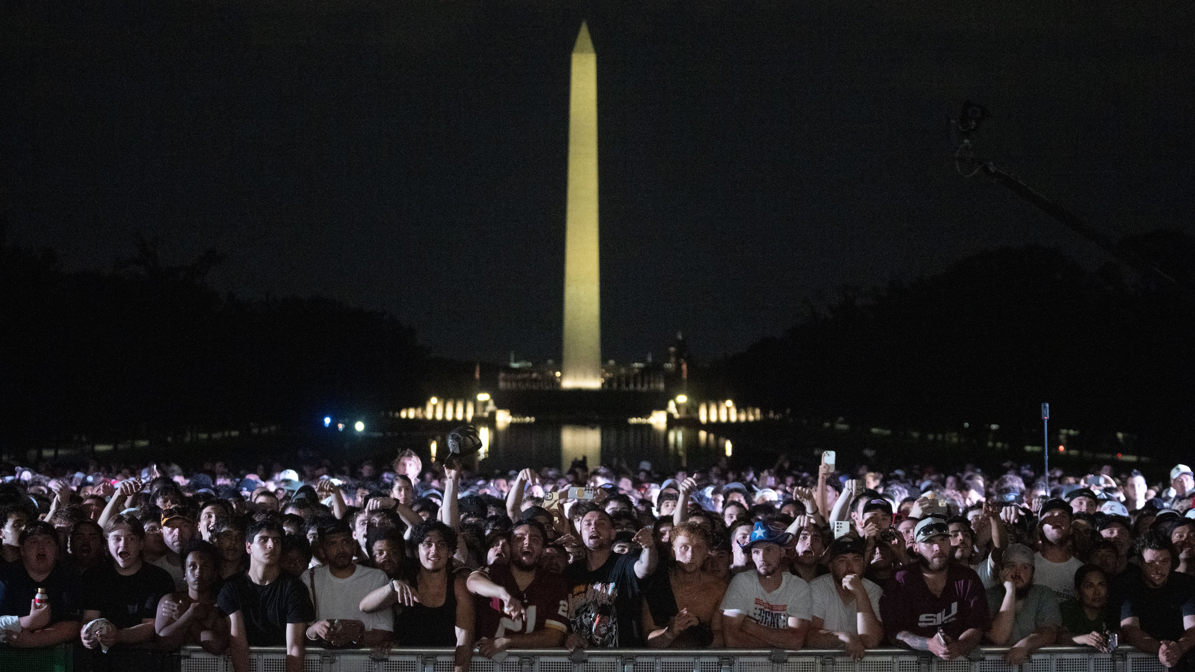 Audience members cheer and boo during a UFC news conference at the Lincoln Memorial, ahead of Sunday's fight on the South Lawn of the White House, Friday, June 12, 2026, in Washington. (AP Photo/Allison Robbert)