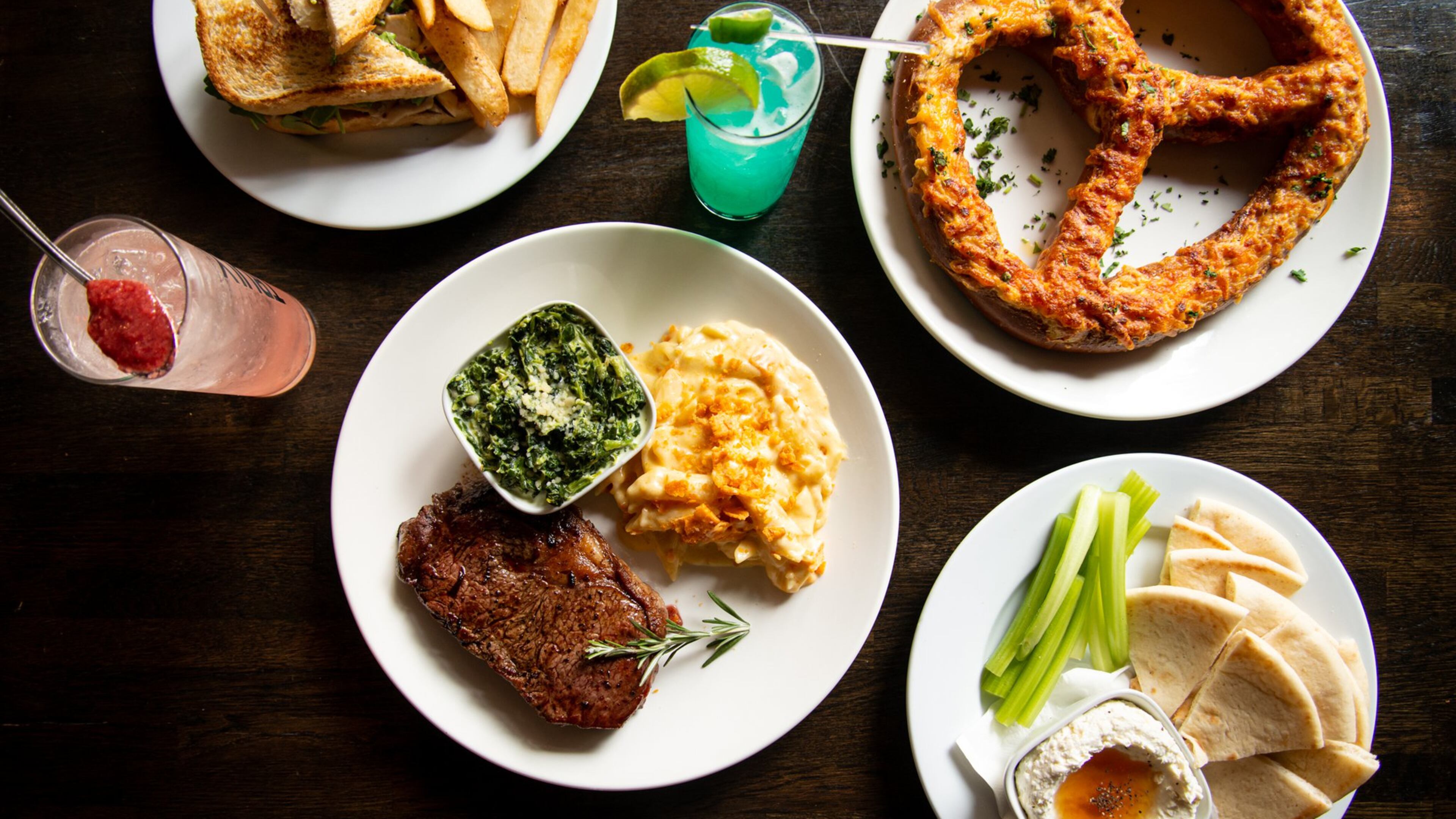 The Daily Tavern Cast Iron Ribeye, Pretzel, Whipped Feta, Warm Smoked Turkey Sandwich and Ghostface and AJC cocktails. Photo credit- Mia Yakel.