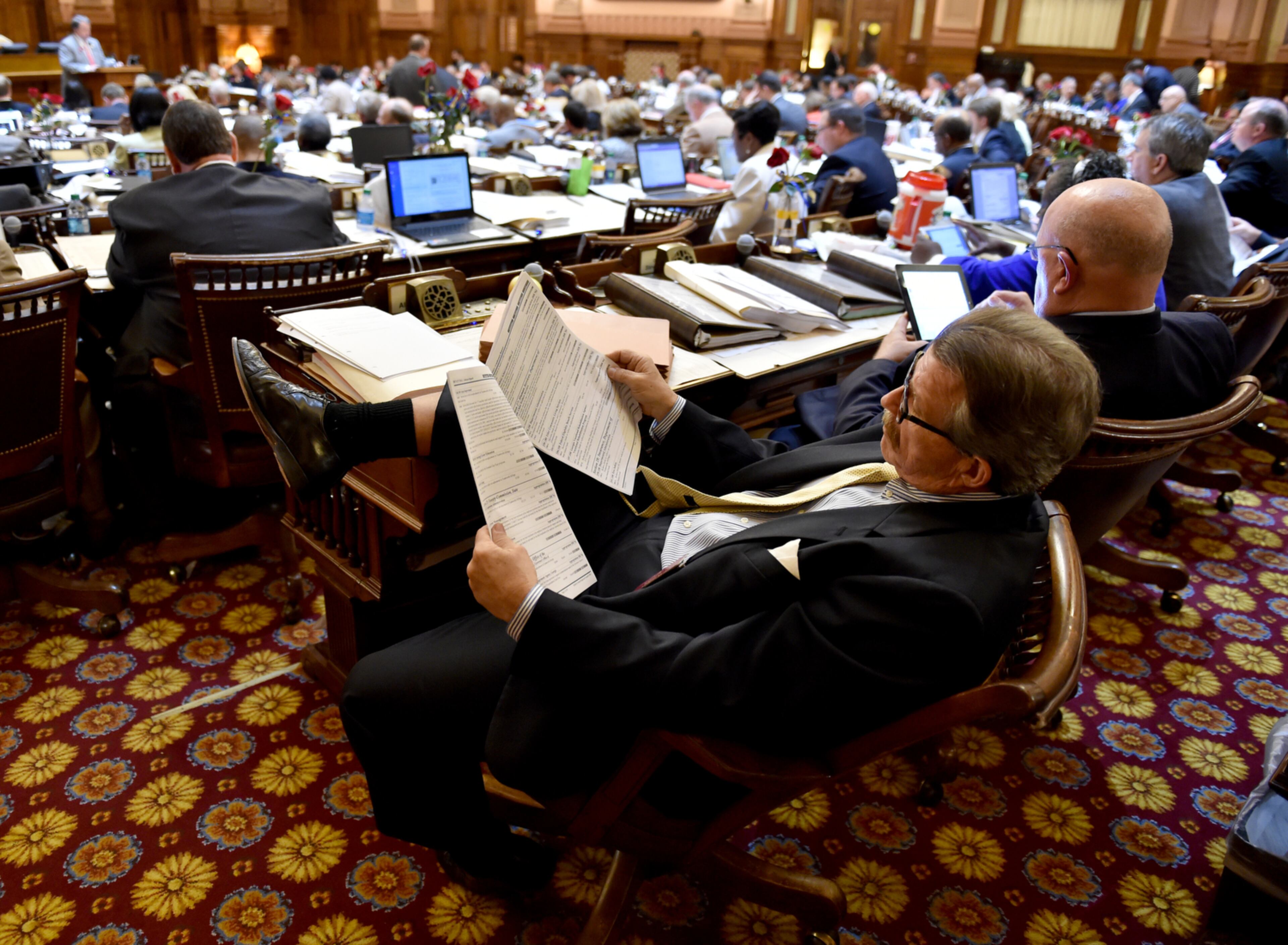 BUDGET APPROVED--March 31, 2015 Atlanta: Rep. Alan Powell reads the committee report on the state budget before House members approved the measure late Tuesday night March 31, 2015. BRANT SANDERLIN/BSANDERLIN@AJC.COM