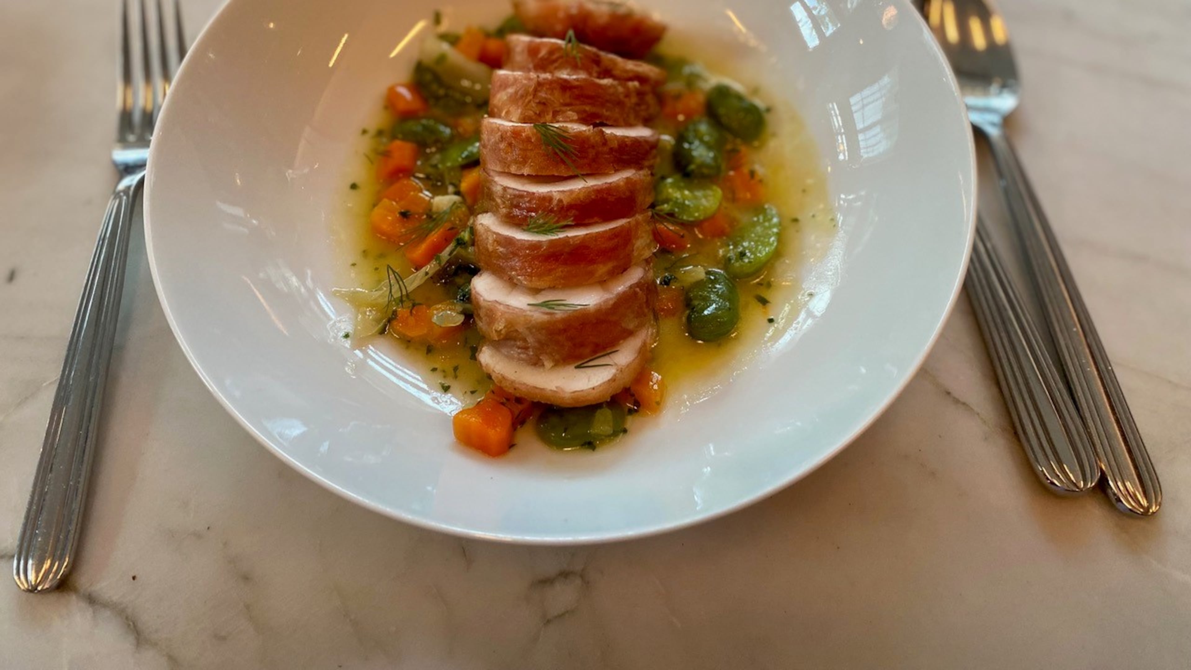 What makes Lucian’s monkfish with favas, fennel and carrots so extraordinary is that it’s encased in a thin sheath of speck. Wendell Brock for The Atlanta Journal-Constitution