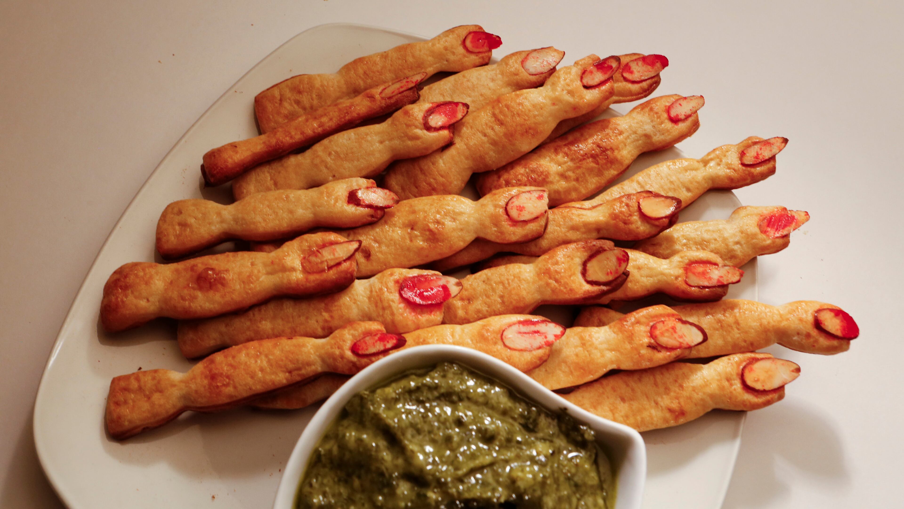 Cut pre-made breadstick dough into finger lengths. Place the fingers on a baking sheet, pinching the dough together in places to form knuckles. Top with egg wash and sliced almonds to make the finger nails. Serve alongside a pesto or marinara dipping sauce. (Anne Cusack/Los Angeles Times/MCT)