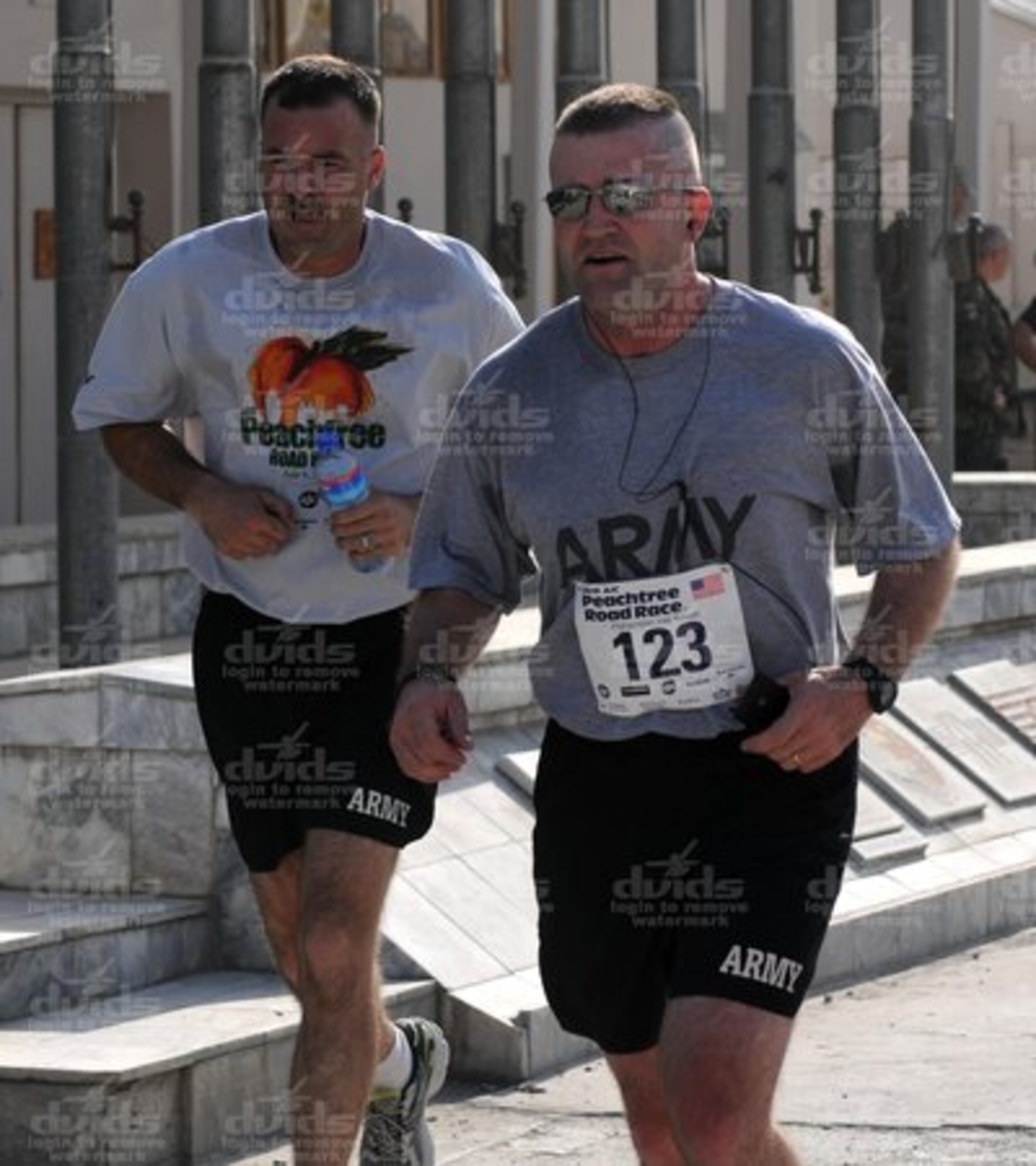 In Kabul, Capt. Brain Dreyer (left) and Maj. Peter Jerzak, both of the South Dakota Army National Guard, cross the finish line during the Peachtree Road Race, Afghanistan division, July 4.