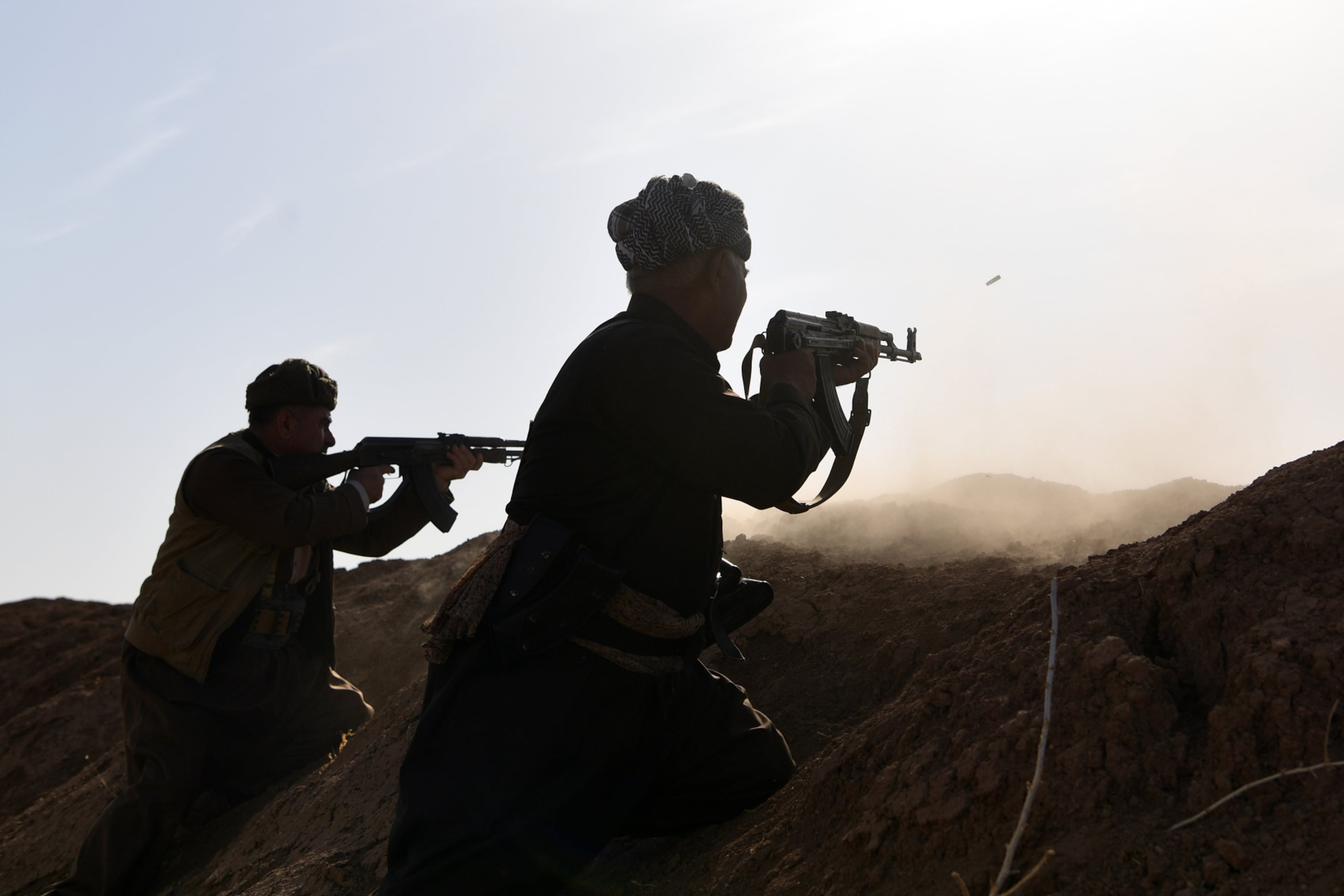 MOSUL, IRAQ - OCTOBER 20: Kurdish peshmerga fighters fire at an ISIS position during an assault to recapture the village of Tiskharab on October 20, 2016 near Mosul, Iraq. Kurdish and Iraqi forces, supported by numerous countries including Britain and the USA, have continued their advance towards towards Iraq's second largest city of Mosul which has been held by Islamic State militants since 2014. (Photo by Carl Court/Getty Images)