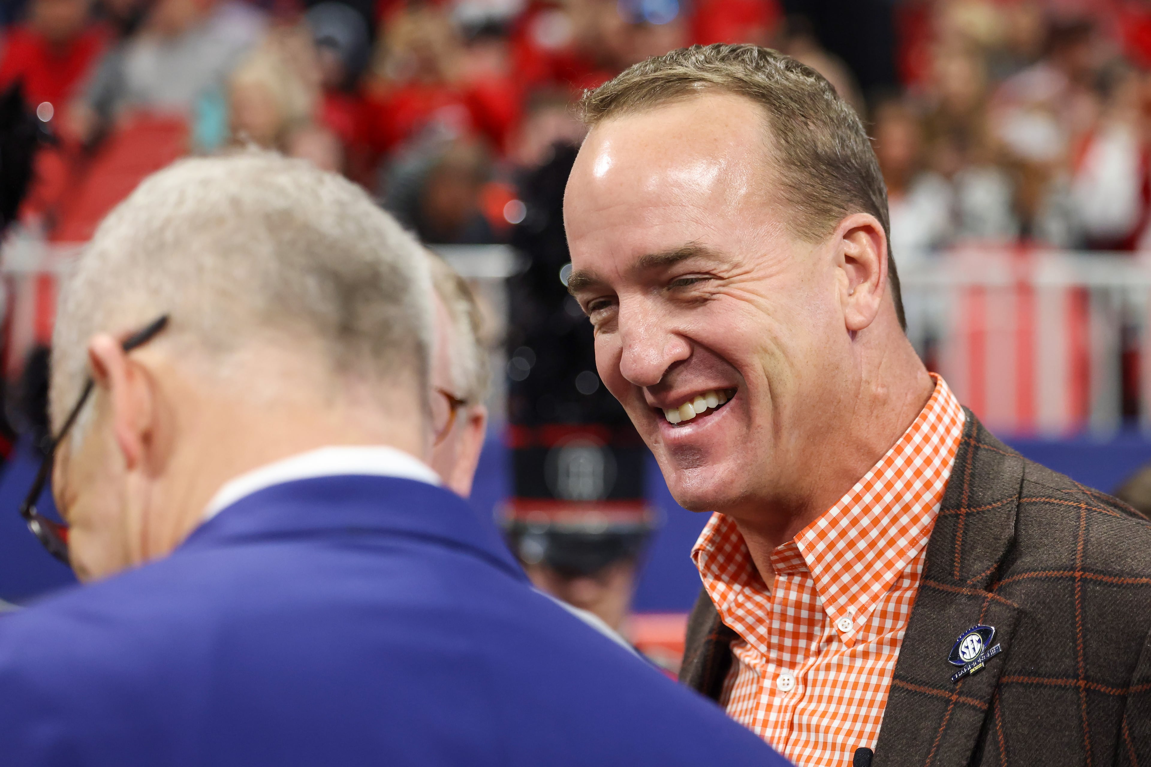 Football great Peyton Manning greets SEC Commissioner Greg Sankey during the SEC Championship Game at Mercedes-Benz Stadium in Atlanta on Saturday, Dec. 3, 2022. (Jason Getz / Jason.Getz@ajc.com)