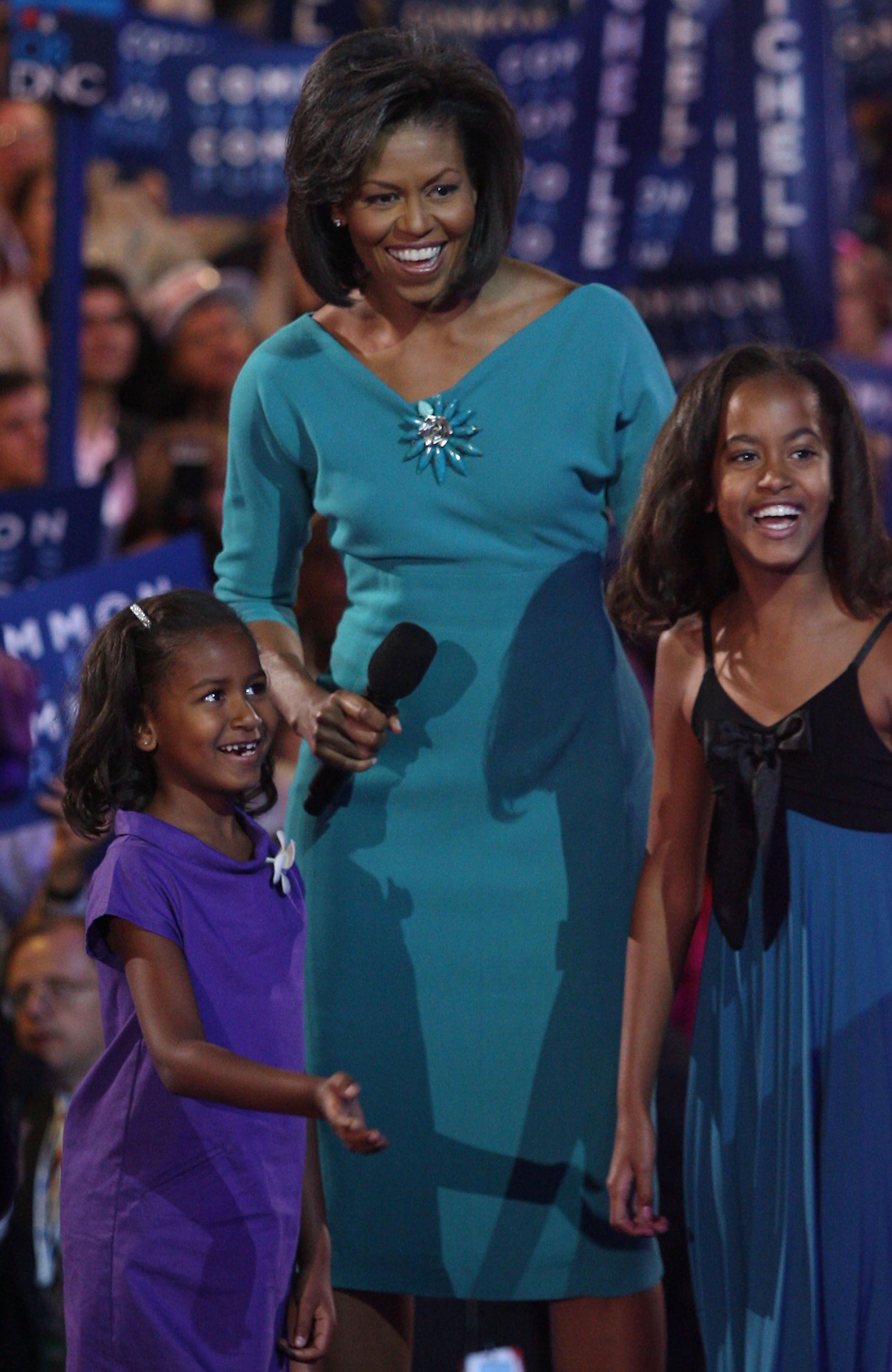 Michelle Obama (C), wife of presumptive Democratic nominee U.S. Sen. Barack Obama (D-IL), stands with her daughters Sasha (L) and Malia during day one of the Democratic National Convention (DNC) at the Pepsi Center August 25, 2008 in Denver, Colorado. The DNC, where U.S. Sen. Barack Obama (D-IL) will be officially nominated as the Democratic candidate for U.S. president, starts today and finishes August 28th. (Photo by John Moore/Getty Images)
