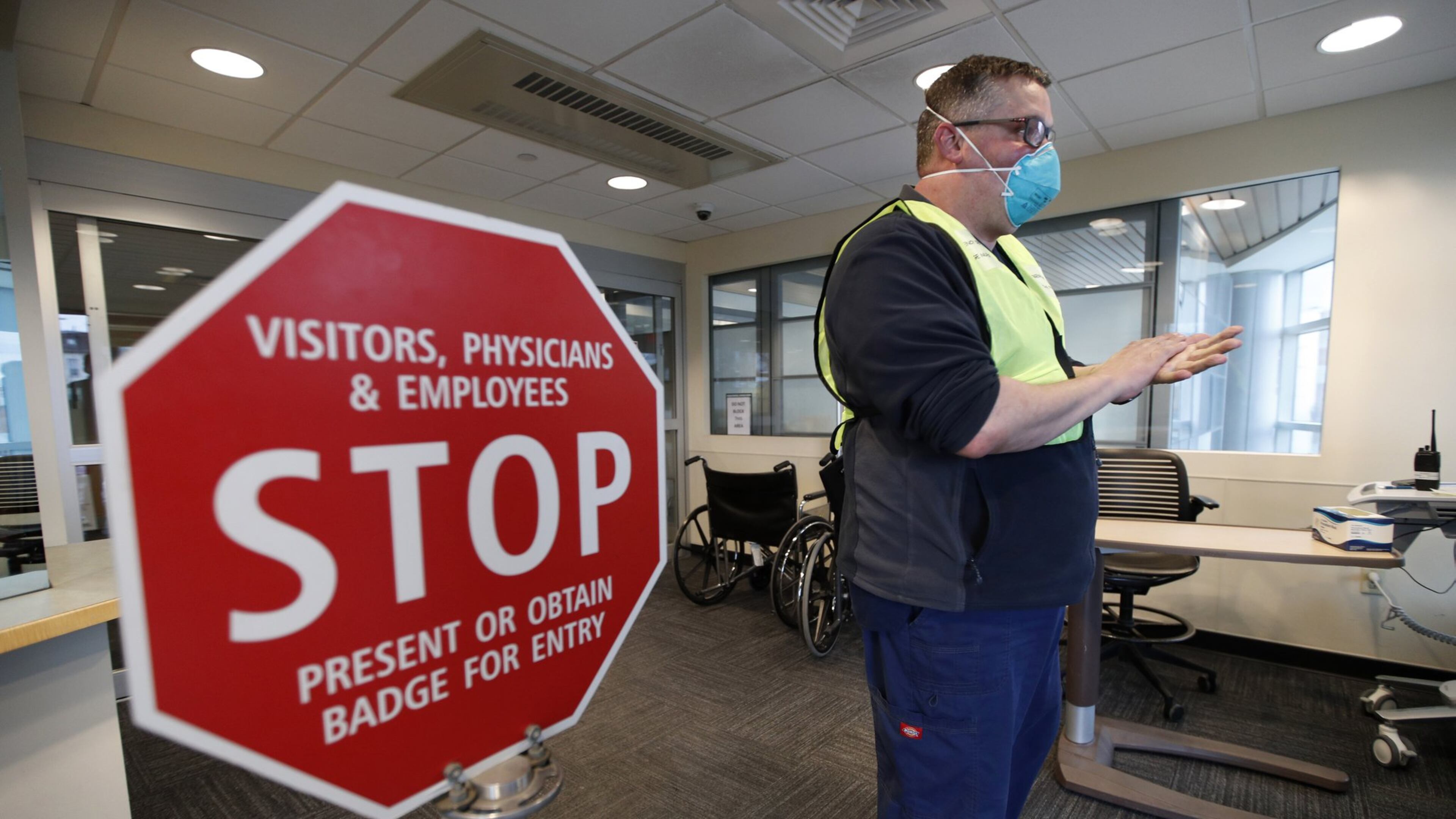 Bradley Mattes, associate nurse leader at Central Maine Medical Center, questions patients at the emergency entrance to the hospital in Lewiston, Maine, Friday, March 13, 2020. (AP Photo/Robert F. Bukaty)