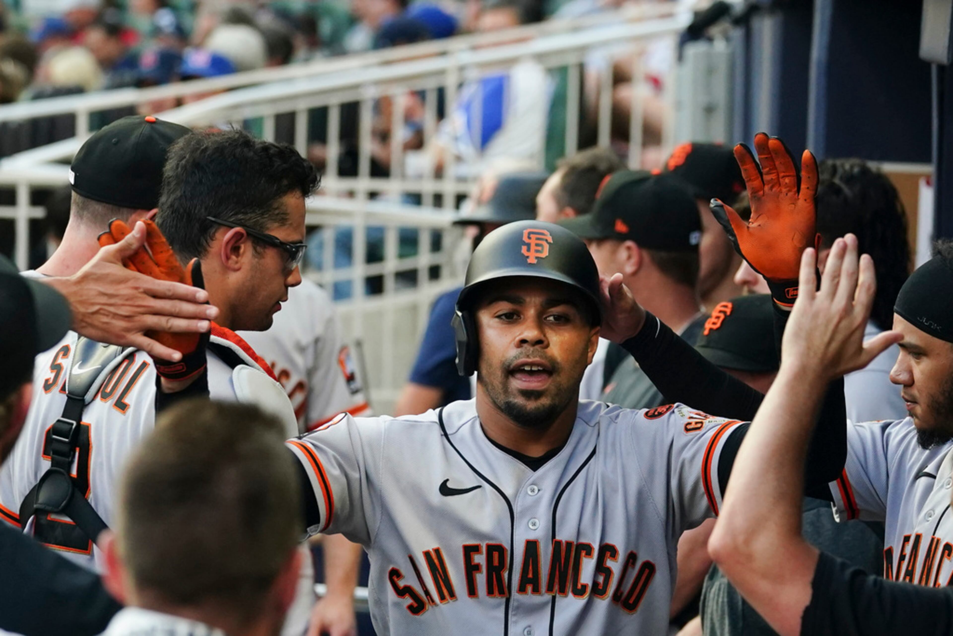 San Francisco Giants' LaMonte Wade Jr. (31) celebrates in the dugout after hitting a home run in the first inning of the team'ss baseball game against the Atlanta Braves on Saturday, Aug. 19, 2023, in Atlanta. (AP Photo/John Bazemore)