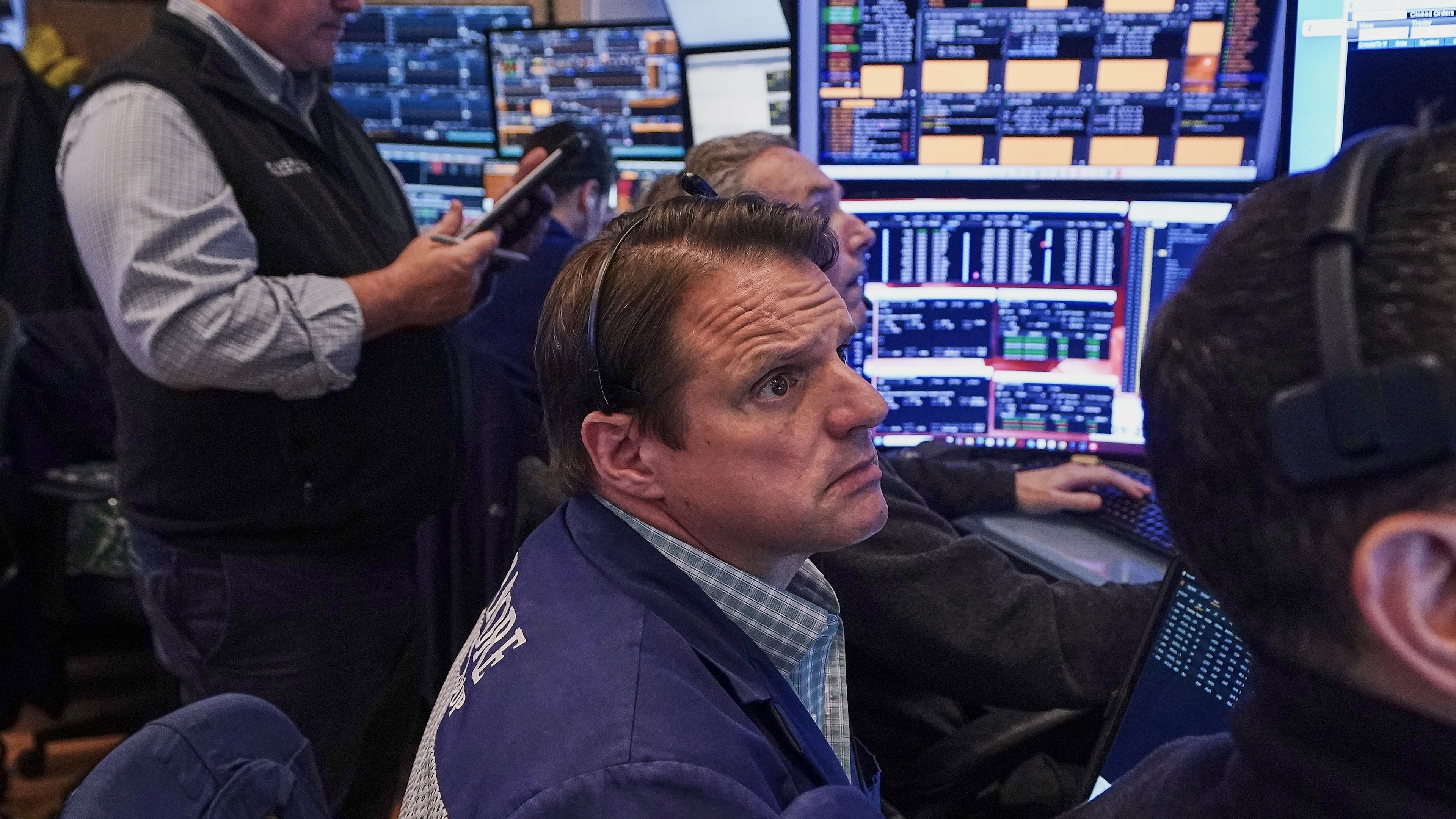 Trader Michael Milano, center, works on the floor of the New York Stock Exchange, Friday, June 26, 2026. (AP Photo/Richard Drew)