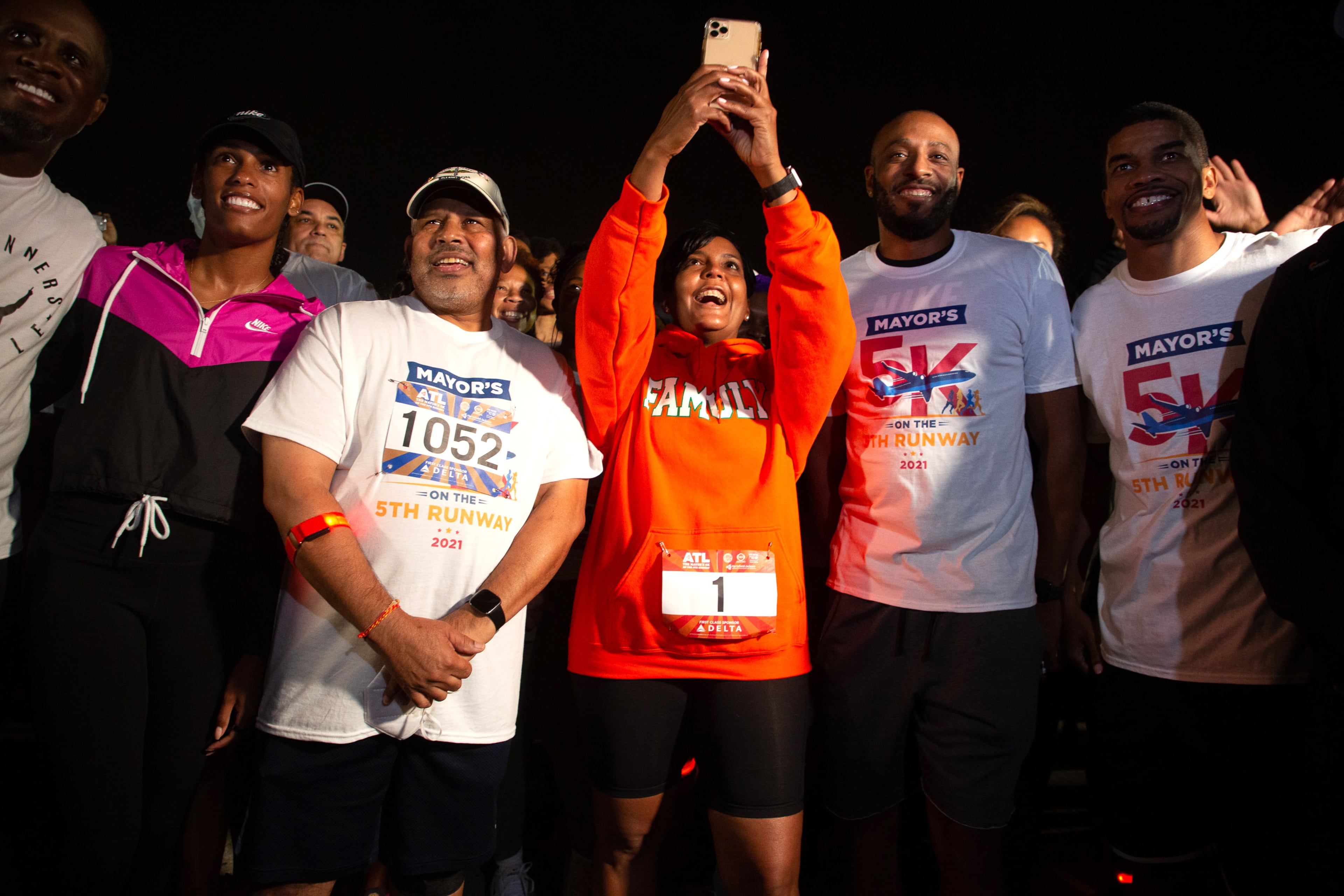 Mayor Keisha Lance Bottoms takes a selfie while standing next to the airport's General Manager Balram Bheodari and Atlanta Olympians moment before the start of the Mayor’s 5K on the 5th Runway at Hartsfield-Jackson International Airport on Saturday morning, October 16, 2021. (Photo: Steve Schaefer for The Atlanta Journal-Constitution)