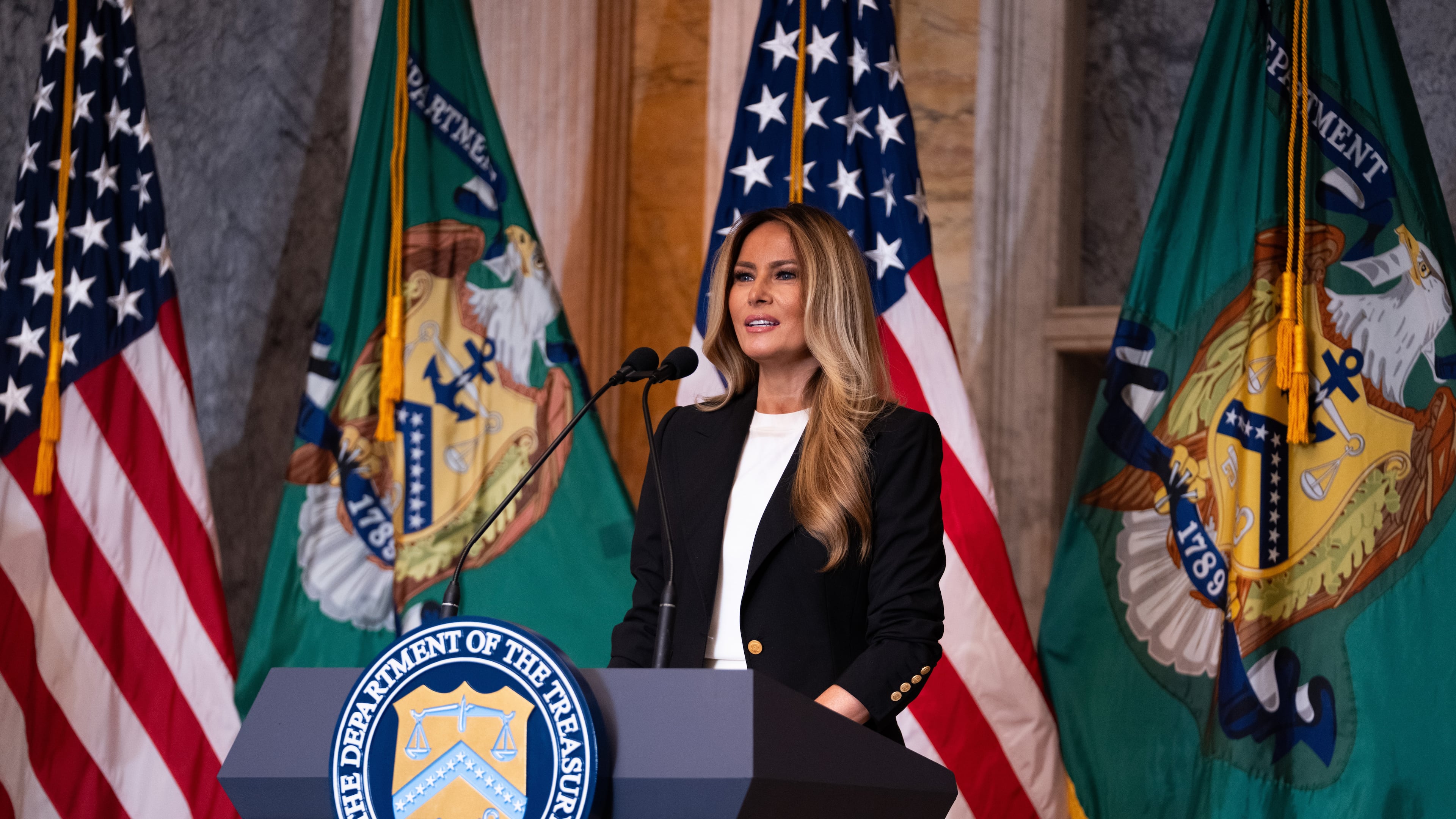 First lady Melania Trump speaks about Trump Accounts for children in foster care at the Department of Treasury, Thursday, June 11, 2026, in Washington. (AP Photo/Allison Robbert)