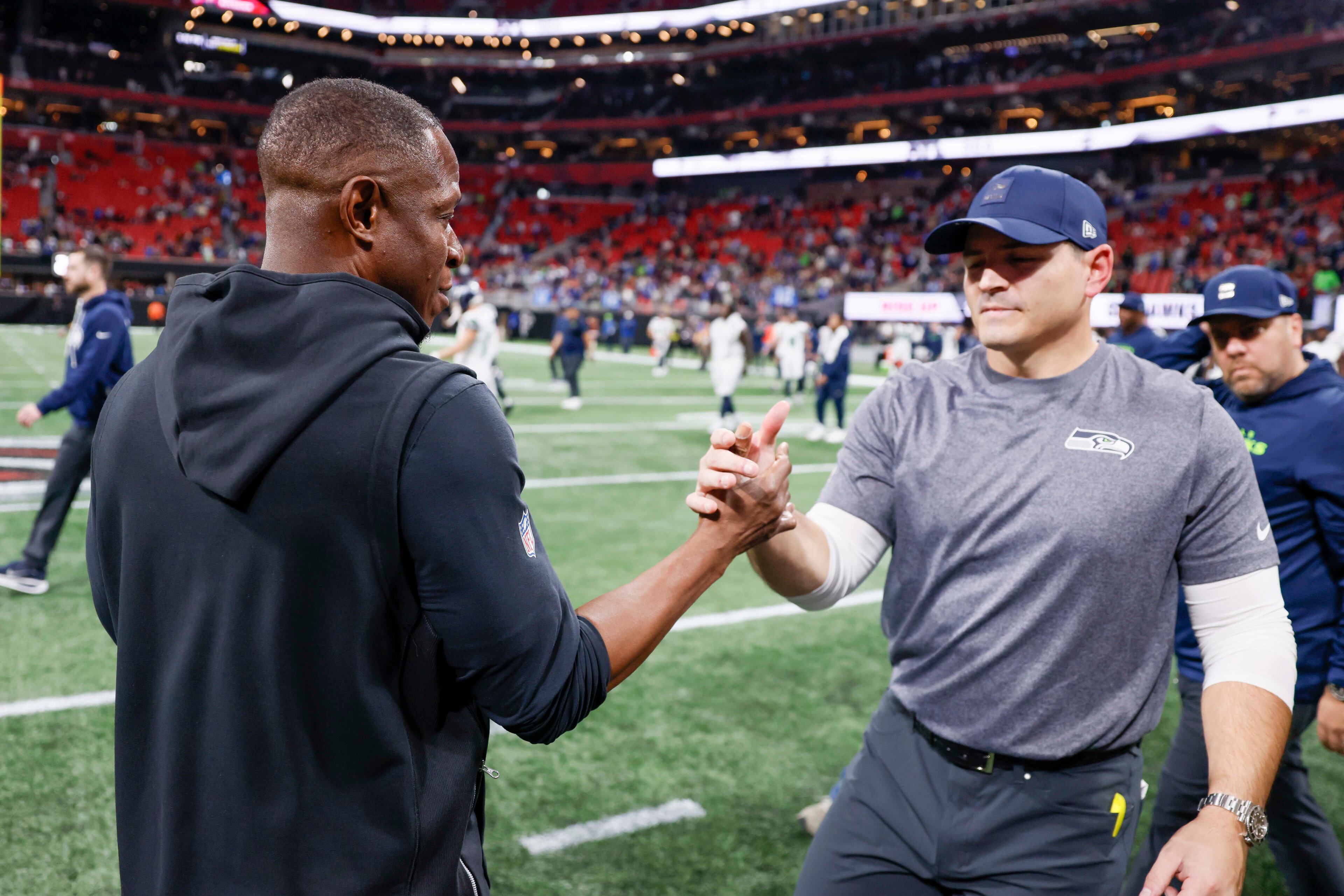 Atlanta Falcons head coach Raheem Morris shakes hands with Seattle Seahawks head coach Mike MacDonald after the game, in which the Seahawks defeated the Falcons 37-9 at Mercedes-Benz Stadium in Atlanta on Sunday, Dec. 7, 2025. (Miguel Martinez/ AJC)