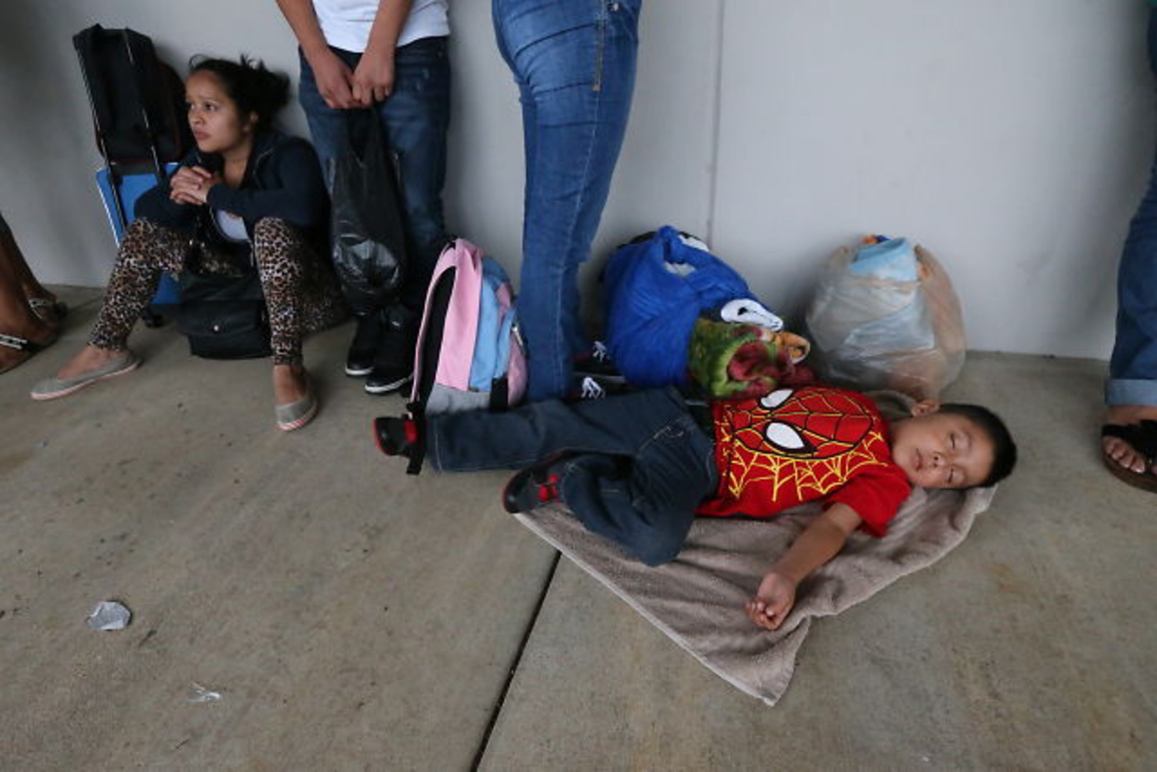 Hoping to get their children enrolled in DeKalb County Schools, immigrant families spent Thursday night and early Friday lined up with their children outside district headquarters.