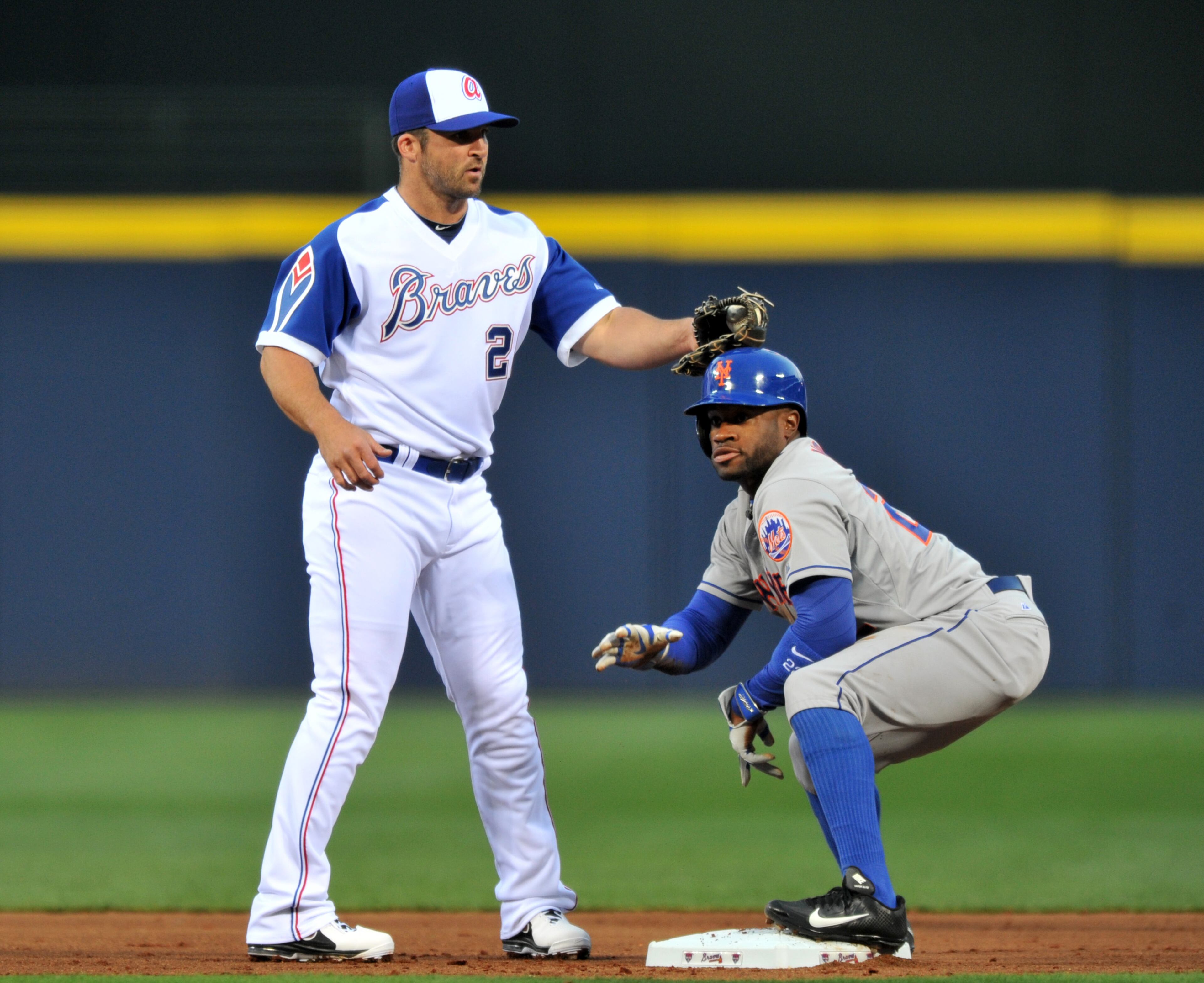 Atlanta Braves Dan Uggla (26) applies a late tag on New York Mets Eric Young Jr. (22) in the first inning of the season opener at Turner Field in Atlanta on Tuesday, April 8, 2014. HYOSUB SHIN / HSHIN@AJC.COM