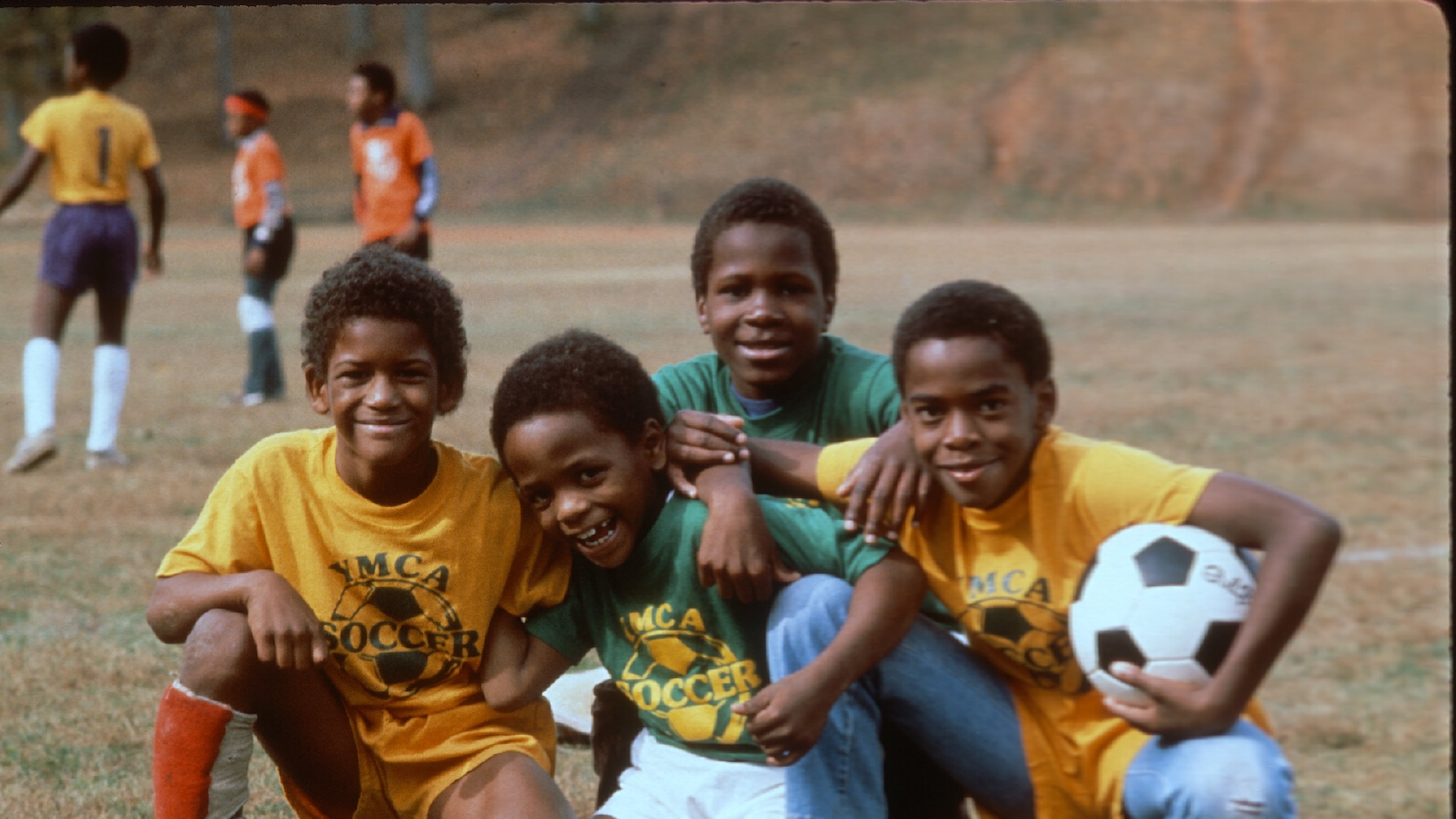 Four boys from a 1980s YMCA soccer team pose for a photo. (Courtesy of YMCA of Metro Atlanta)