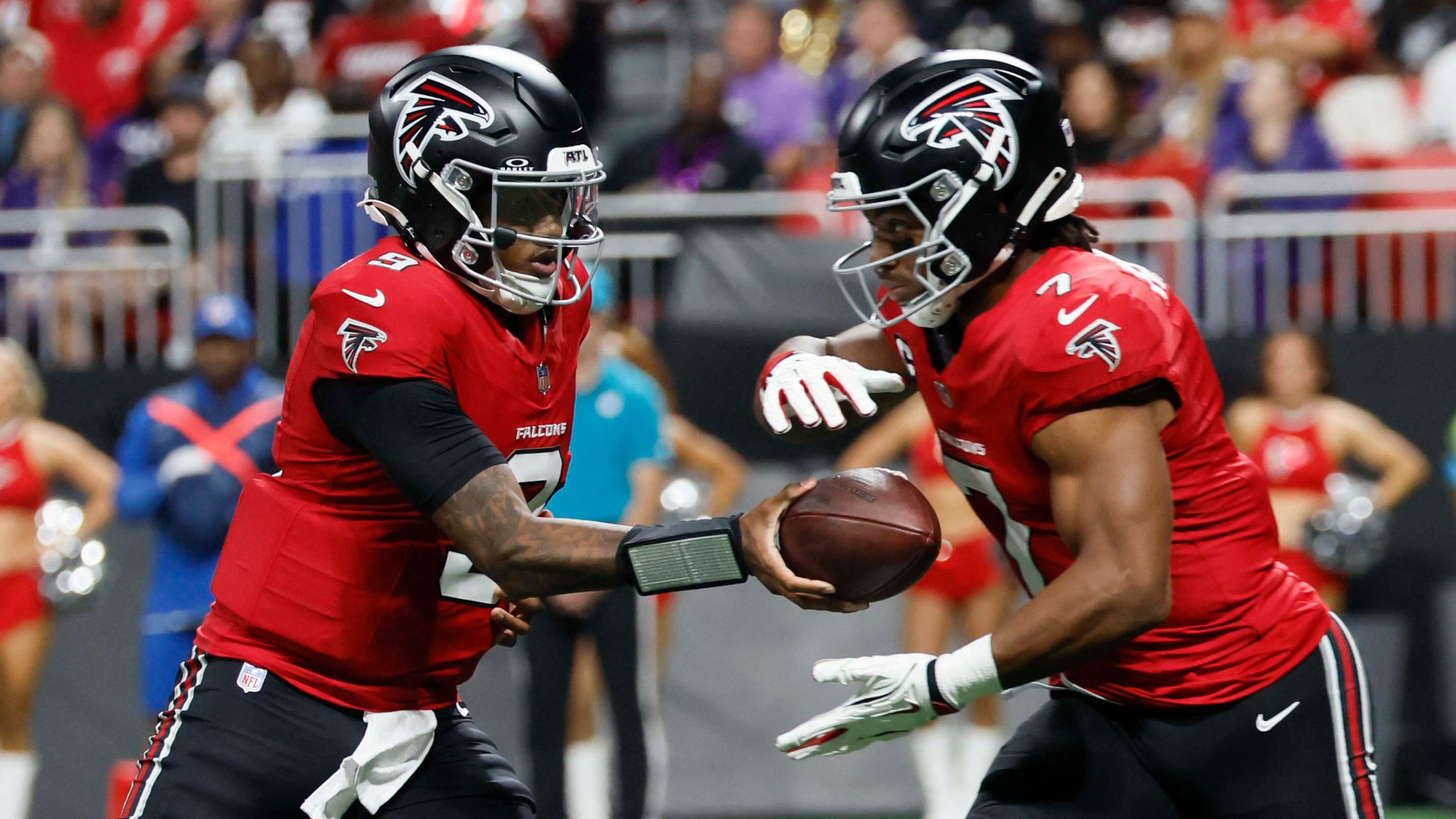 Falcons quarterback Michael Penix Jr. (left) hands the ball to running back Bijan Robinson against the Ravens on Sunday, Oct. 11, 2026, at Mercedes-Benz Stadium in Atlanta. Robinson ran 17 times for 86 yards and had four catches for 32 yards against Baltimore. (Miguel Martinez/AJC)
