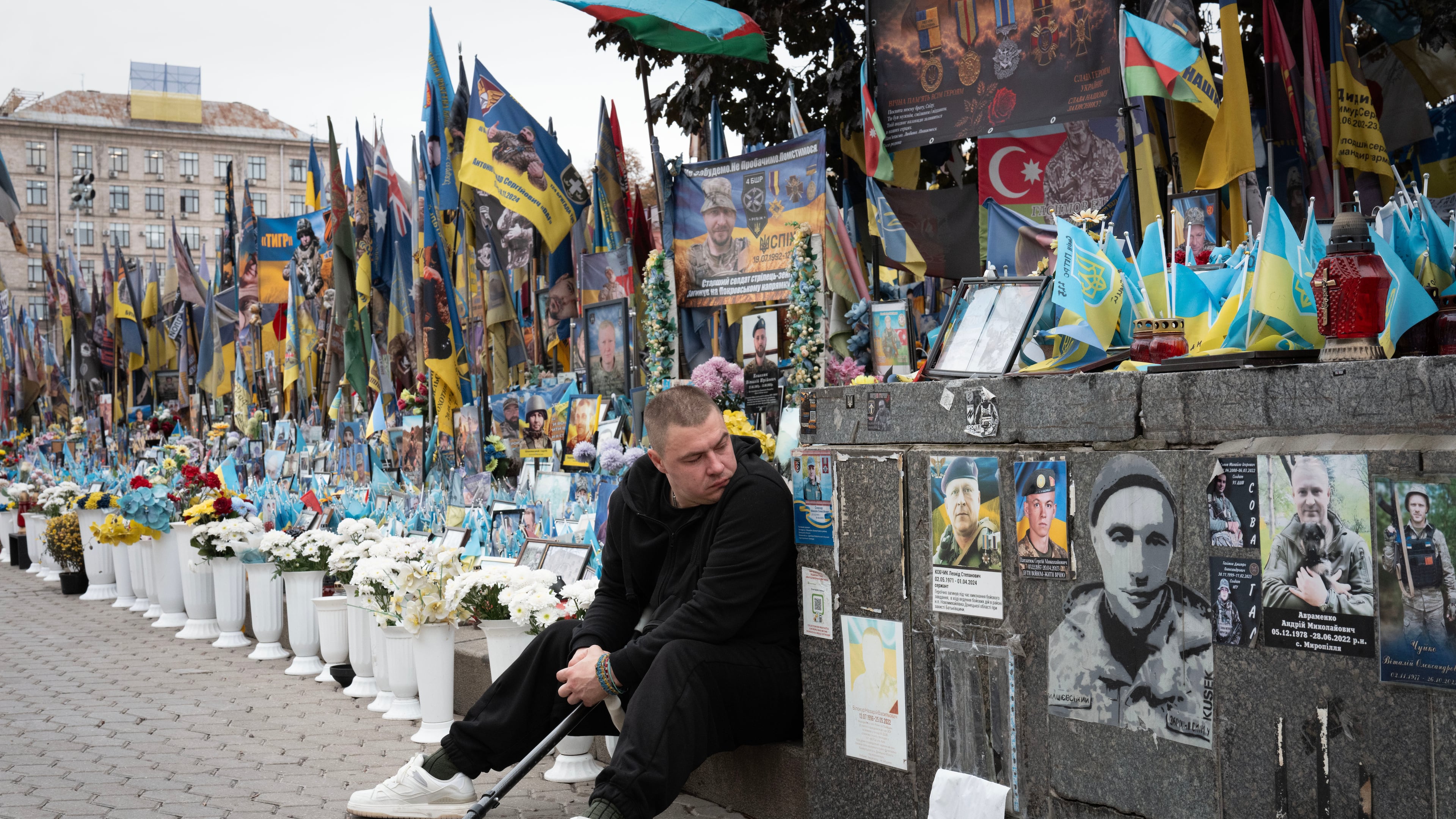 A veteran pays his respects at a makeshift memorial to Ukrainian soldiers killed in the war with Russia, on Independence Square in Kyiv, Ukraine, Monday, Oct. 12, 2026. (AP Photo/Efrem Lukatsky)